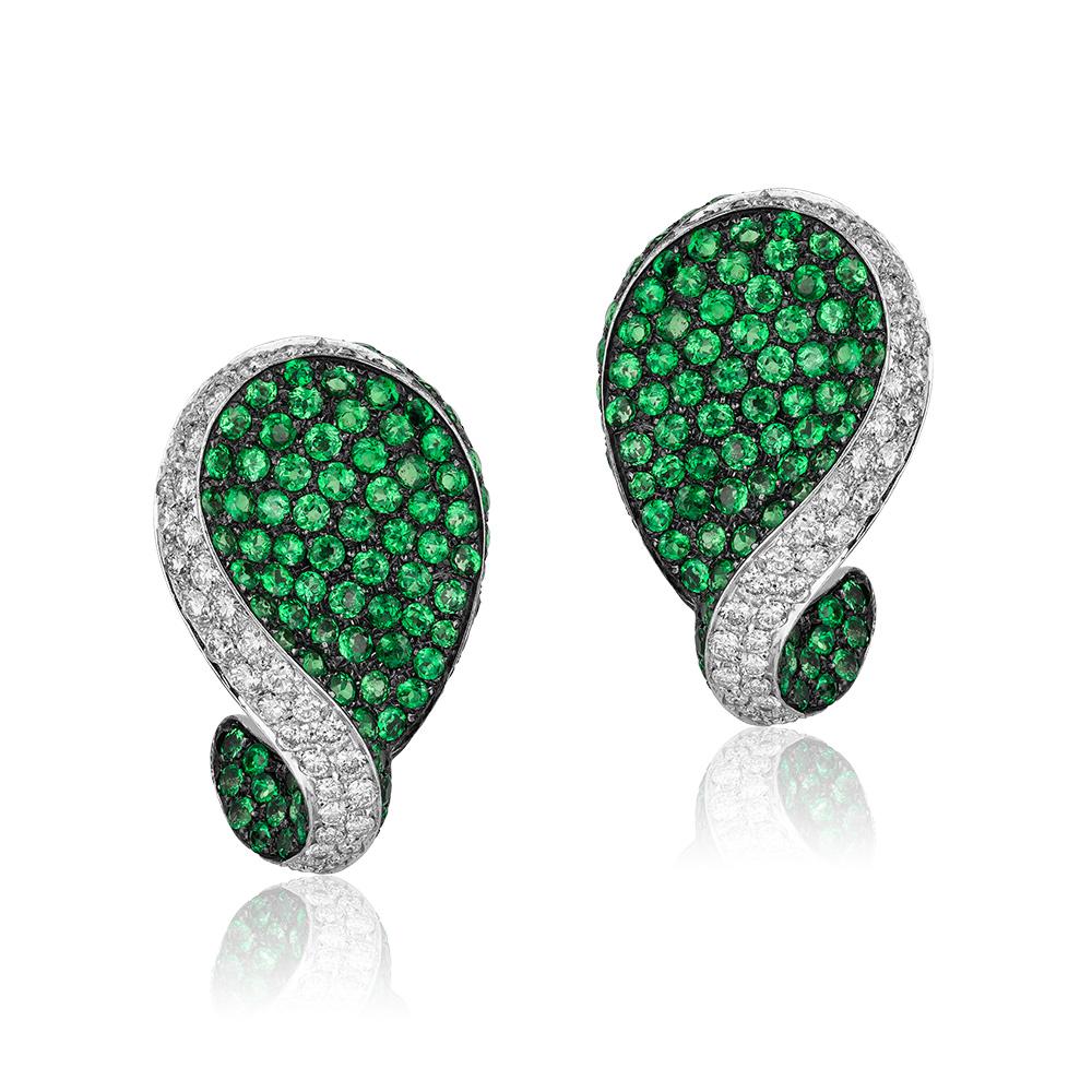 Andreoli Green Tsavorite Garnet Diamond Clip On Earrings 18 Karat White Gold. These earrings feature 8.22 carats of electric green round tsavorite garnets with blackened rhodium underneath. Accented with 1.99 carats of F-G-H Color VS-SI Clarity