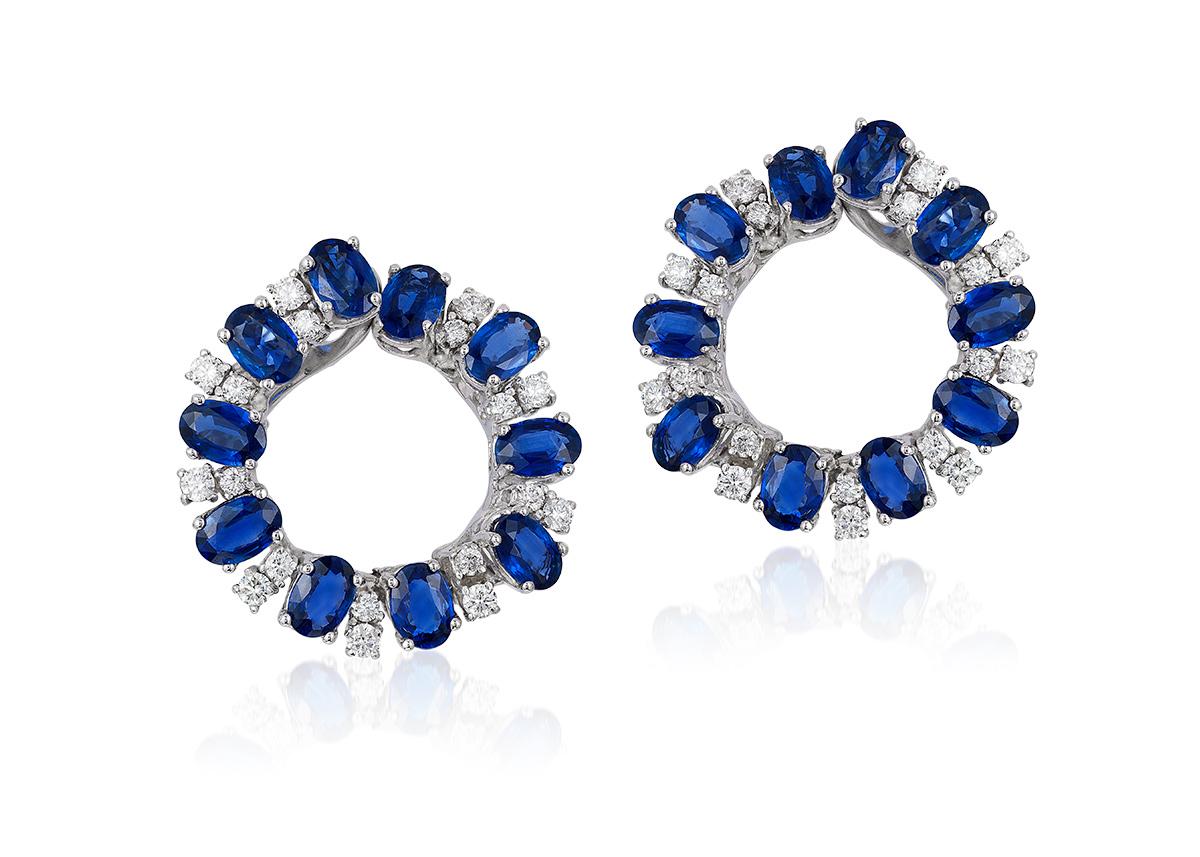 Andreoli Oval Blue Sapphire Diamond Hoop Earrings 18 Karat White Gold. these earrings feature 1.15 carats of F-G-H Color VS-SI Clarity of full round ideal cut brilliant diamonds and 10.15 carats of Blue Sapphire Siam Thailand Origin. Set in 15.23
