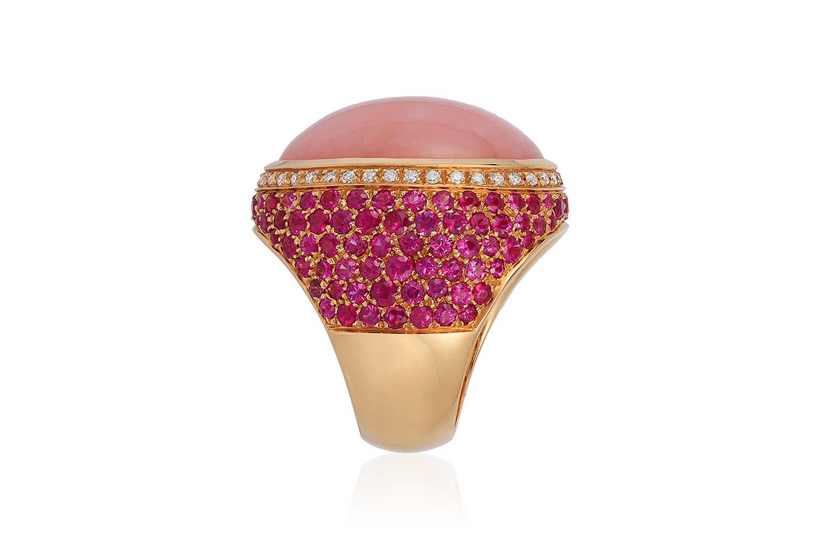Andreoli Rose Opal Pink Sapphire Diamond Dome Cocktail Ring 18 Karat Yellow Gold. This ring features a 19 carat dome shaped rose opal center stone surronded by round brilliant cut ideal 0.35 carats of diamonds. 5.35 carats of round pink sapphires.