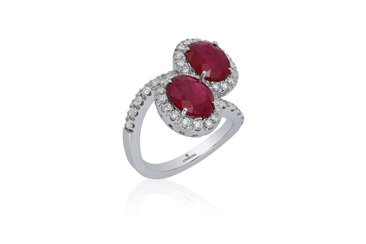 Andreoli Ruby Diamond Bypass CDC Certified Thailand 18 Karat White Gold Cocktail. This ring features 6.12 carats of Thailand origin two oval ruby CDC Certified Intense Red colour. Surrounded by 1.07 carats of round brilliant cut ideal diamond F-G-H
