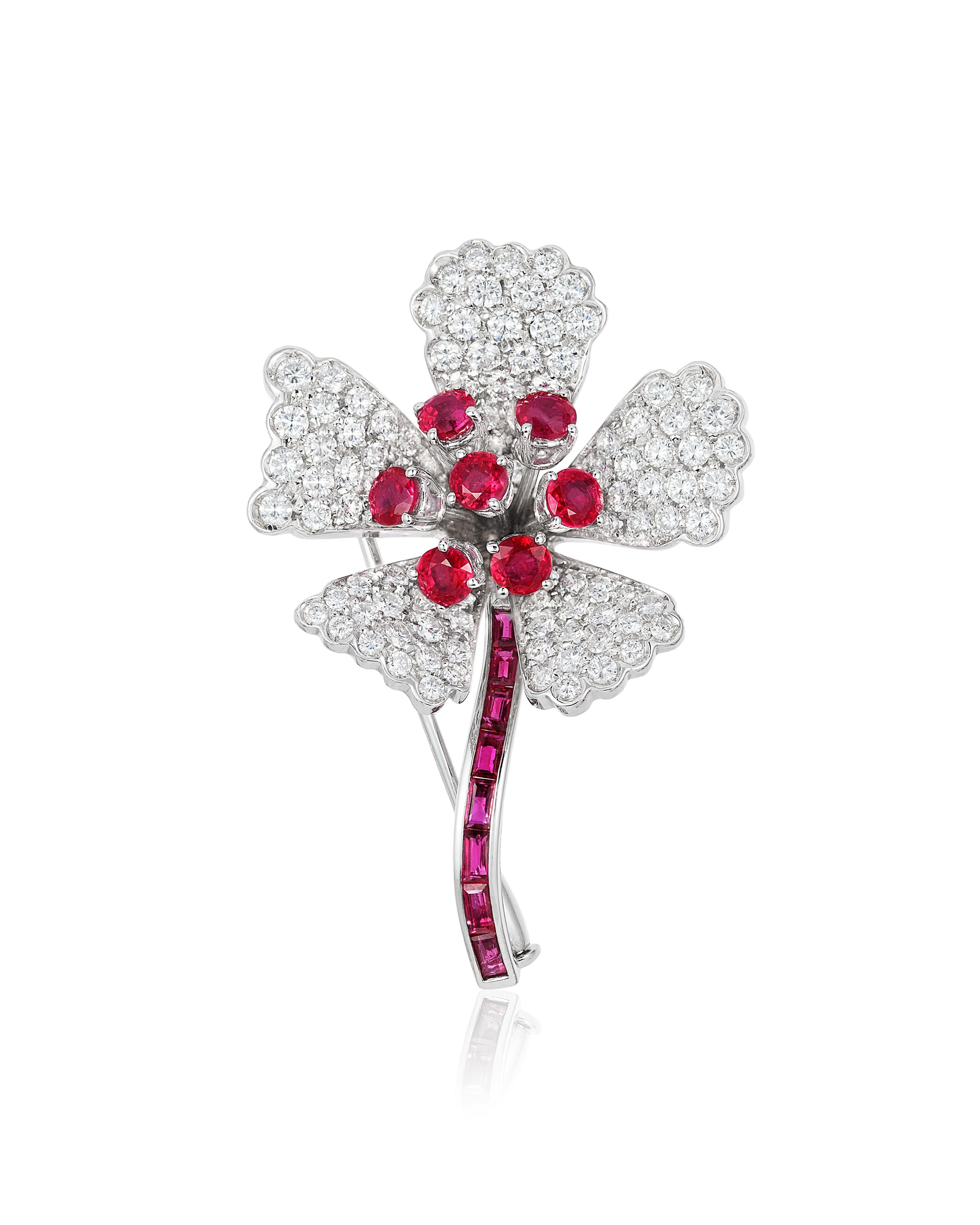 Andreoli Ruby Diamond Flower Brooch Pin 18 Karat White Gold. This brooch features fu 3.16 carat of F-G-H Color VS-SI Clarity of ideal brilliant round cut diamonds. 2.86 carats of Seven red round rubies in the center and eight invisible setting