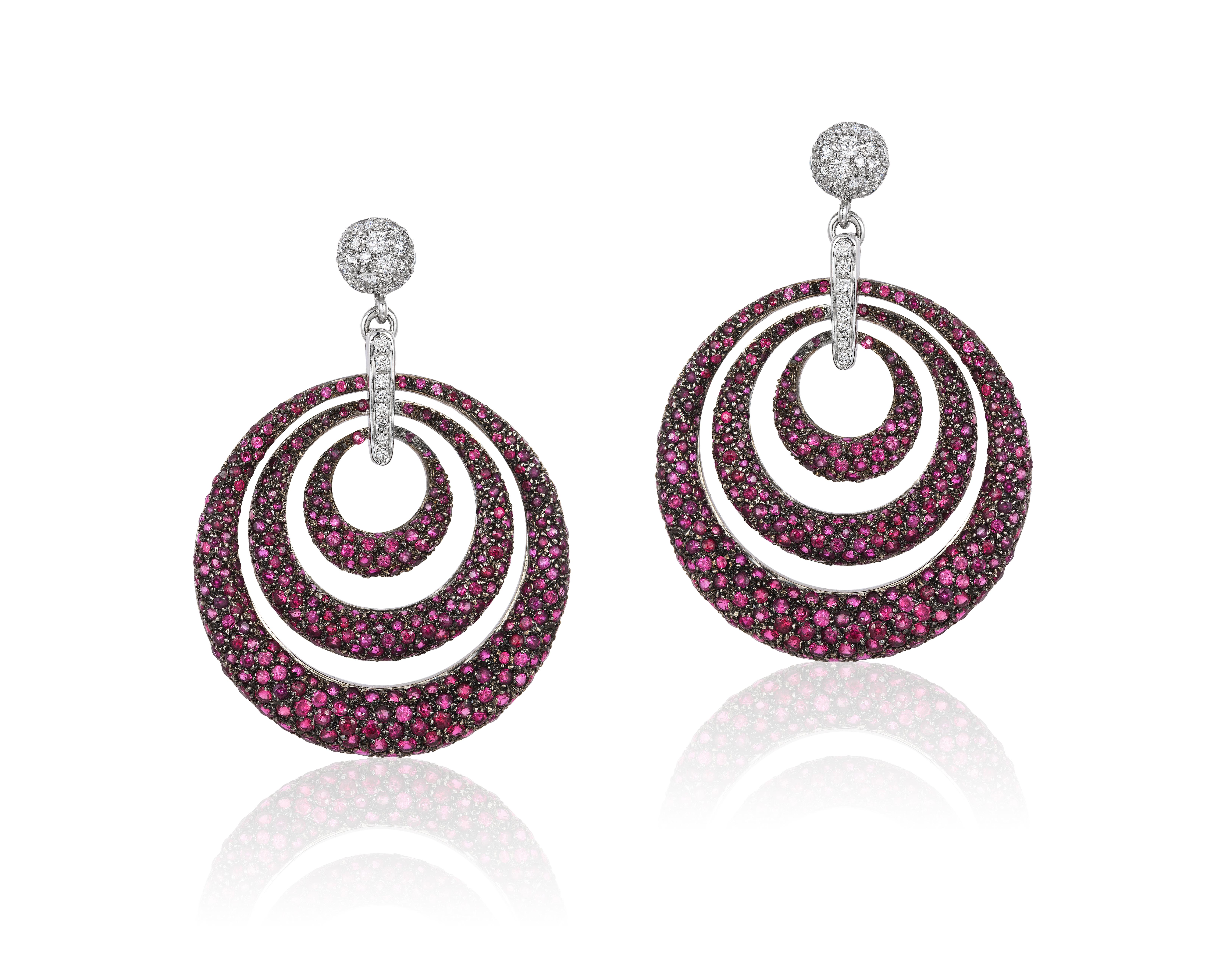 Andreoli Ruby Pave Diamond 18 Karat White Gold Blackened Rhodium Hoop Earrings. These earrings feature 1.31 carats of F-G-H Color VS-SI Clarity full round brilliant cut diamonds, 13.53 carats of round ruby pave, blackened rhodium, 40.80gm 18KT White