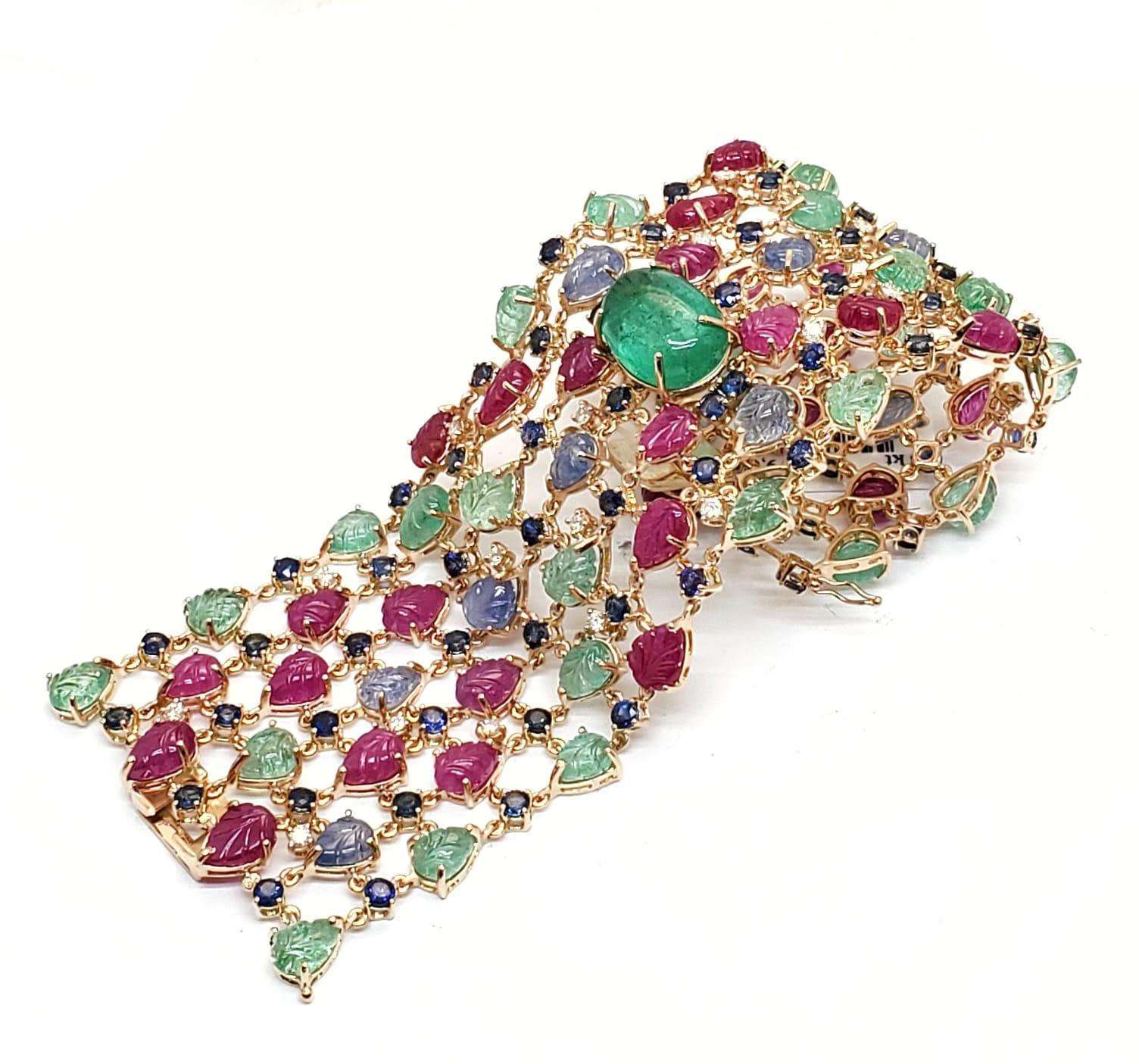 Andreoli Sapphire Emerald Ruby Leaves Colombian Cabochon Diamond 18 Karat Rose Gold Bracelet. 

This bracelet features 1.59 carats of F-G-H Color VS-SI Clarity full round brilliant cut diamonds. 34.52 carats of Blue Sapphire carved leaves, 34.45