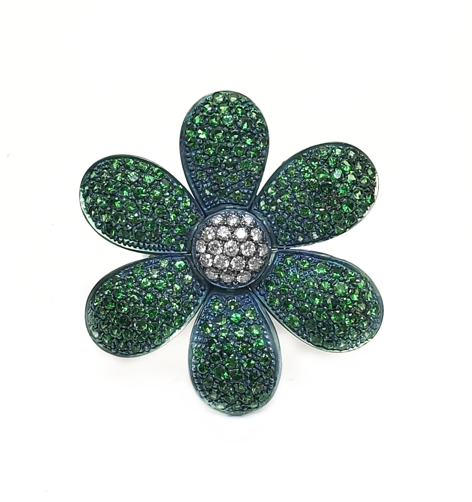  Andreoli Titanium Tsavorite Green Garnet Diamond Flower Cocktail Ring 18KT. Andreoli was one of the first jewelry creators to utilize titanium in high jewelry over 18KT or Platinum. The use of titanium allows for bigger and bolder designs without