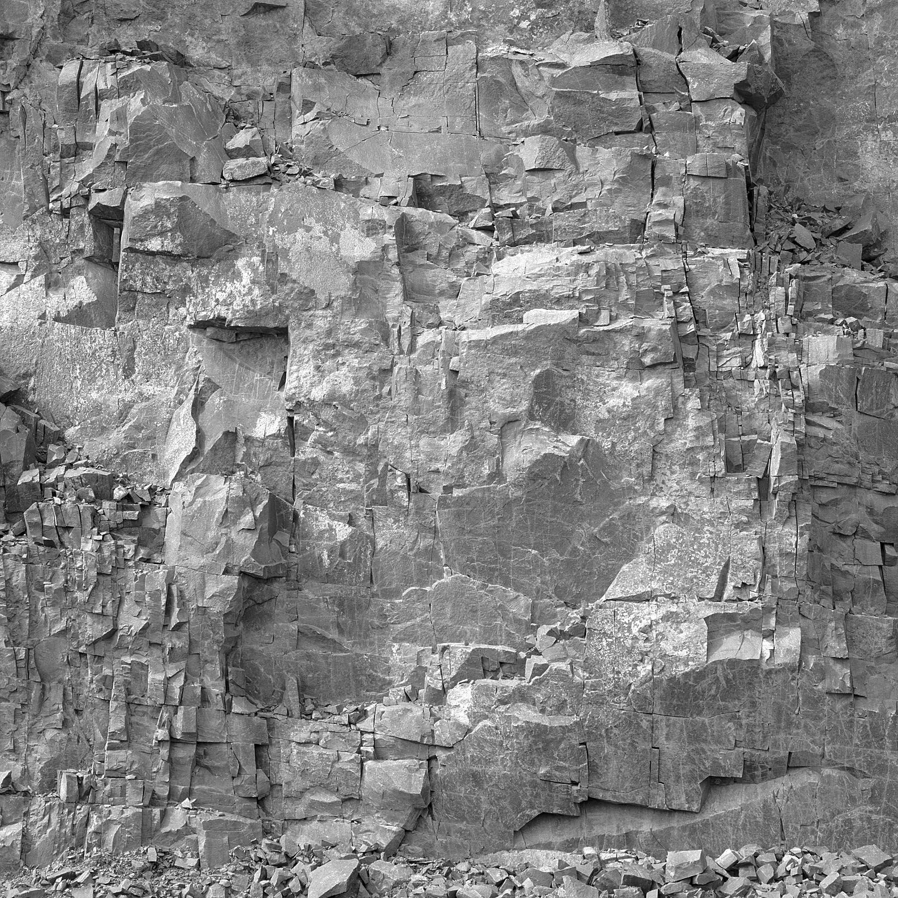 Andrew Buck Landscape Photograph - Rockface 27: Still Life of Graphic Jagged Rock Cliff in Black and White)