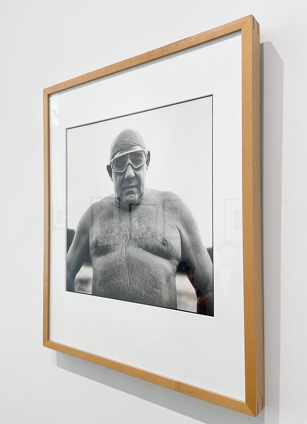Ian - El Club de Natación Serpentine, de Andrew Buurman, es una fotografía en blanco y negro de un hombre mayor, calvo y sin camiseta, con gafas, todavía mojado de nadar.

Impresión en plata gelatina
Edición 25/2
Firmado, titulado, fechado y