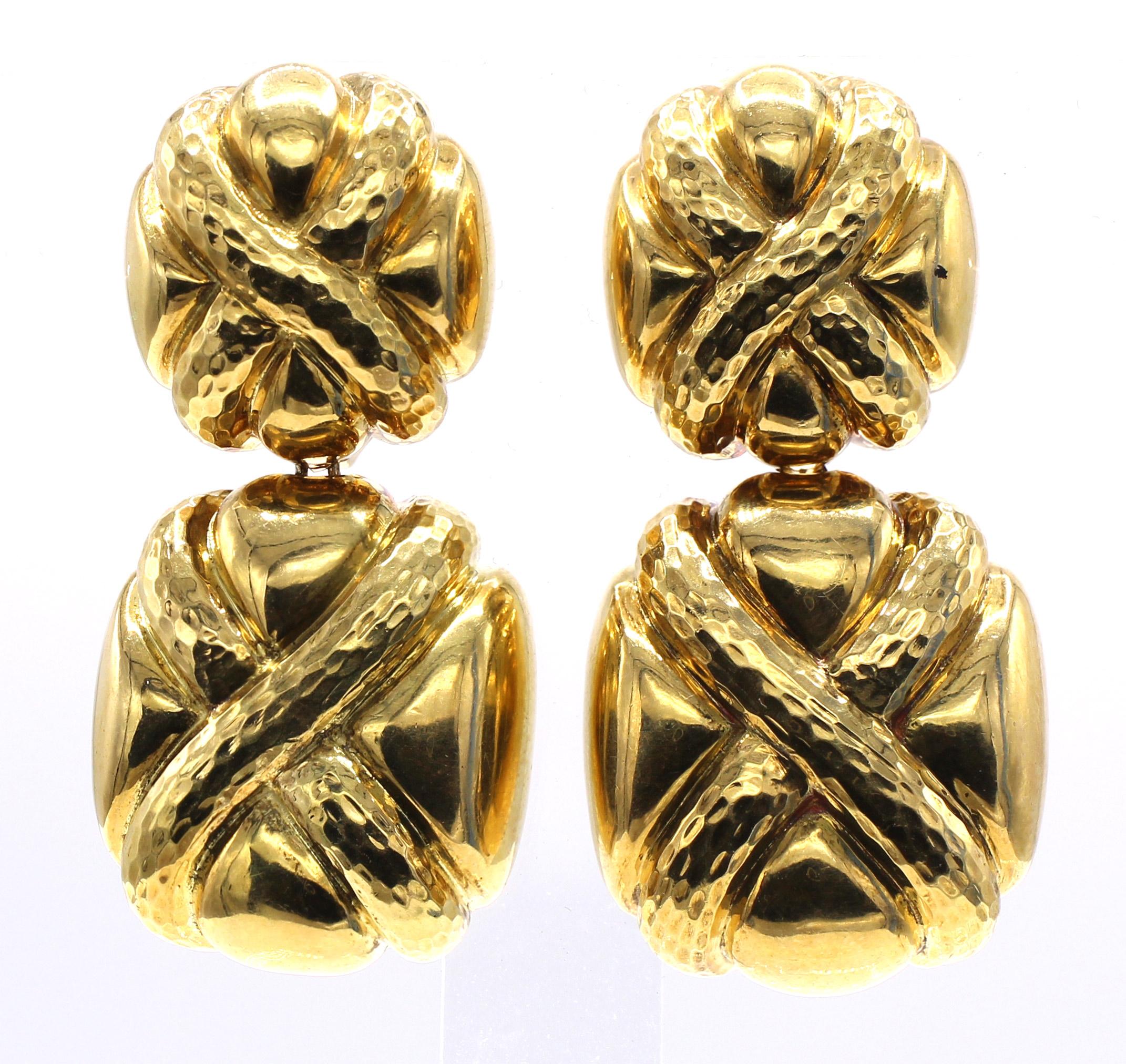 Beautifully designed and masterfully handcrafted 1980s 18 karat gold ear pendants. Worked in hammered and polished gold . Secured by wide omega clip-backs. Signed A.Clunn. 