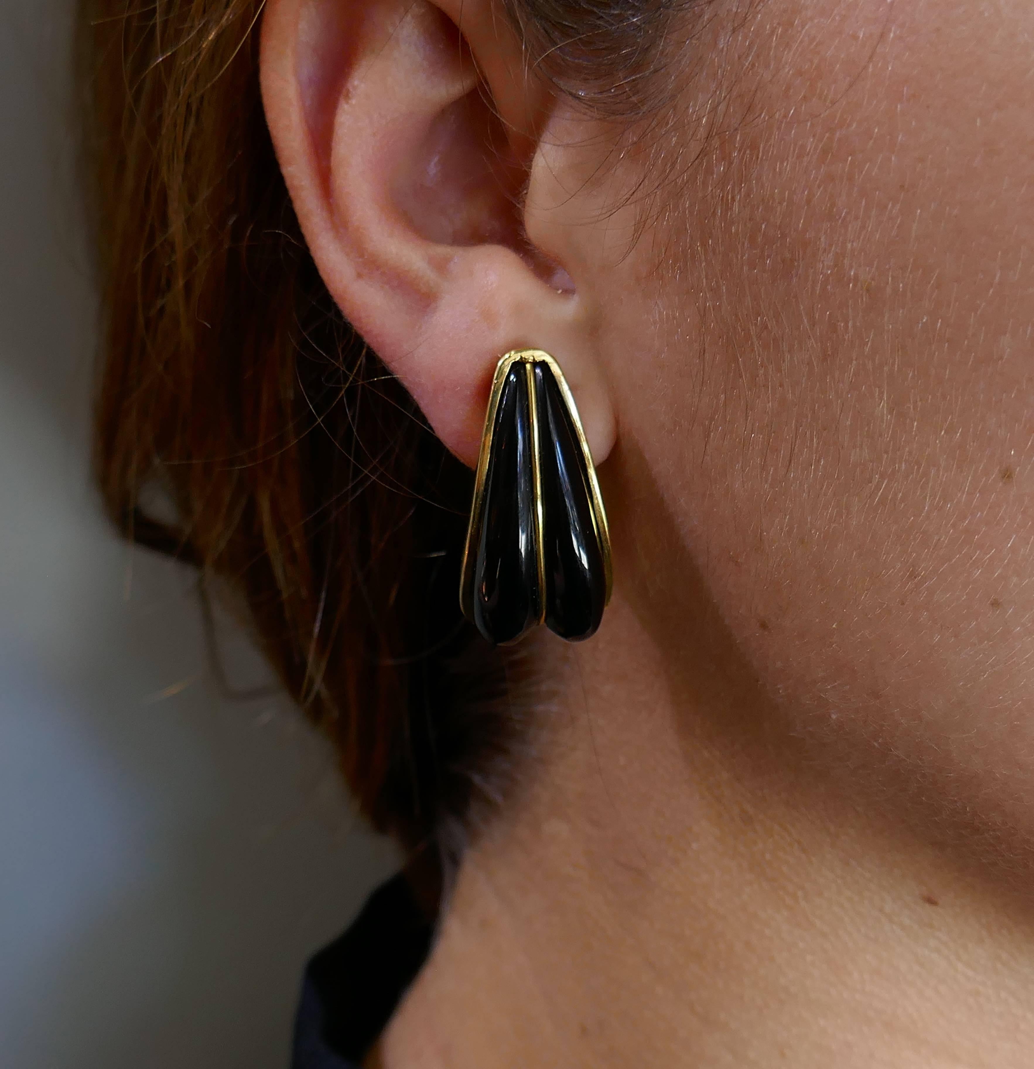 Understated and elegant clip-on earrings created by Andrew Clunn in the 1970's. Sharp, chic and wearable, the earrings are a great addition to your jewelry collection. 
Made of black onyx and 18k (stamped) yellow gold. 
The earrings measure 1-1/4 x