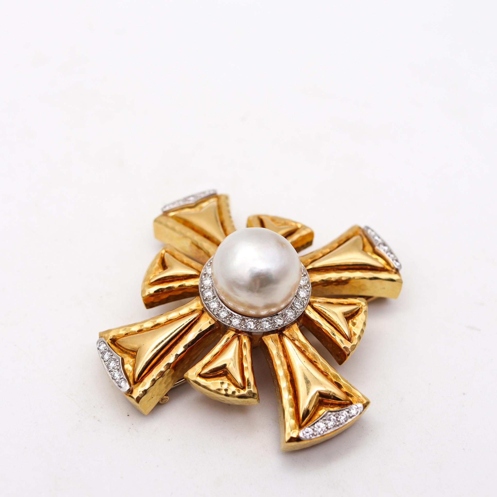 Pendant brooch designed by Andrew Clunn.

Gorgeous convertible pendant-brooch, created in New York city at the jewelry atelier of Andrew Clunn. This piece has been crafted in the shape of a Maltese cross with hammered patterns in solid rich yellow