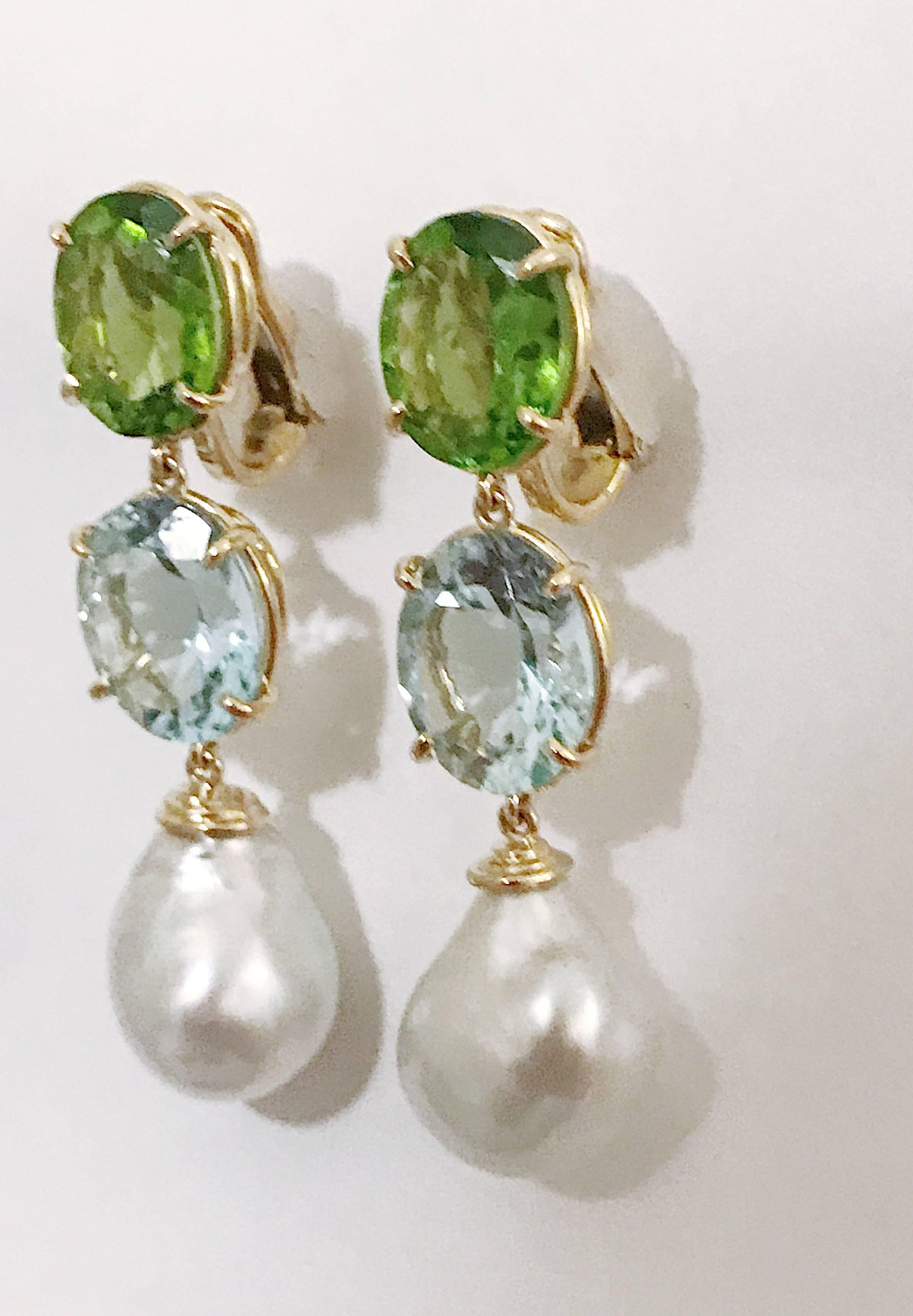 18kt Yellow Gold Elegant Three Stone Drop Earrings with faceted Peridot Aquamarine and South Sea Pearl.

They are stamped A. Clunn.

The Earrings measure 2 1/4 in length. The earrings can be made for Clip Earring or Pierced Earrings.

They can also