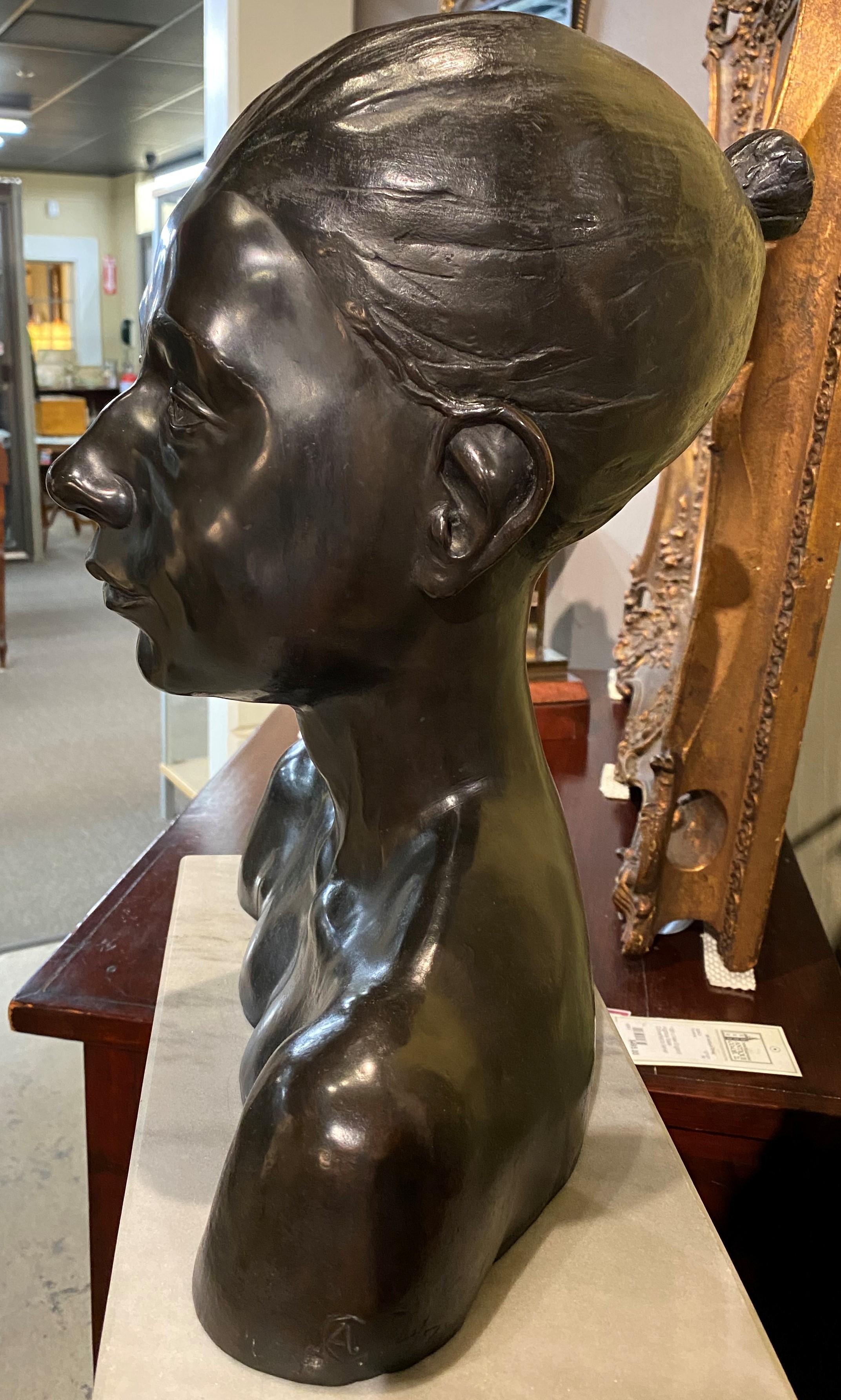 A fine cast patinated bronze bust of a woman with her hair tied back by American artist Andrew Coppola (1941-1992). Coppola was an active artist in Connecticut, known for his  figural sculptures. This bust is monogrammed on the base AC, dated ‘65