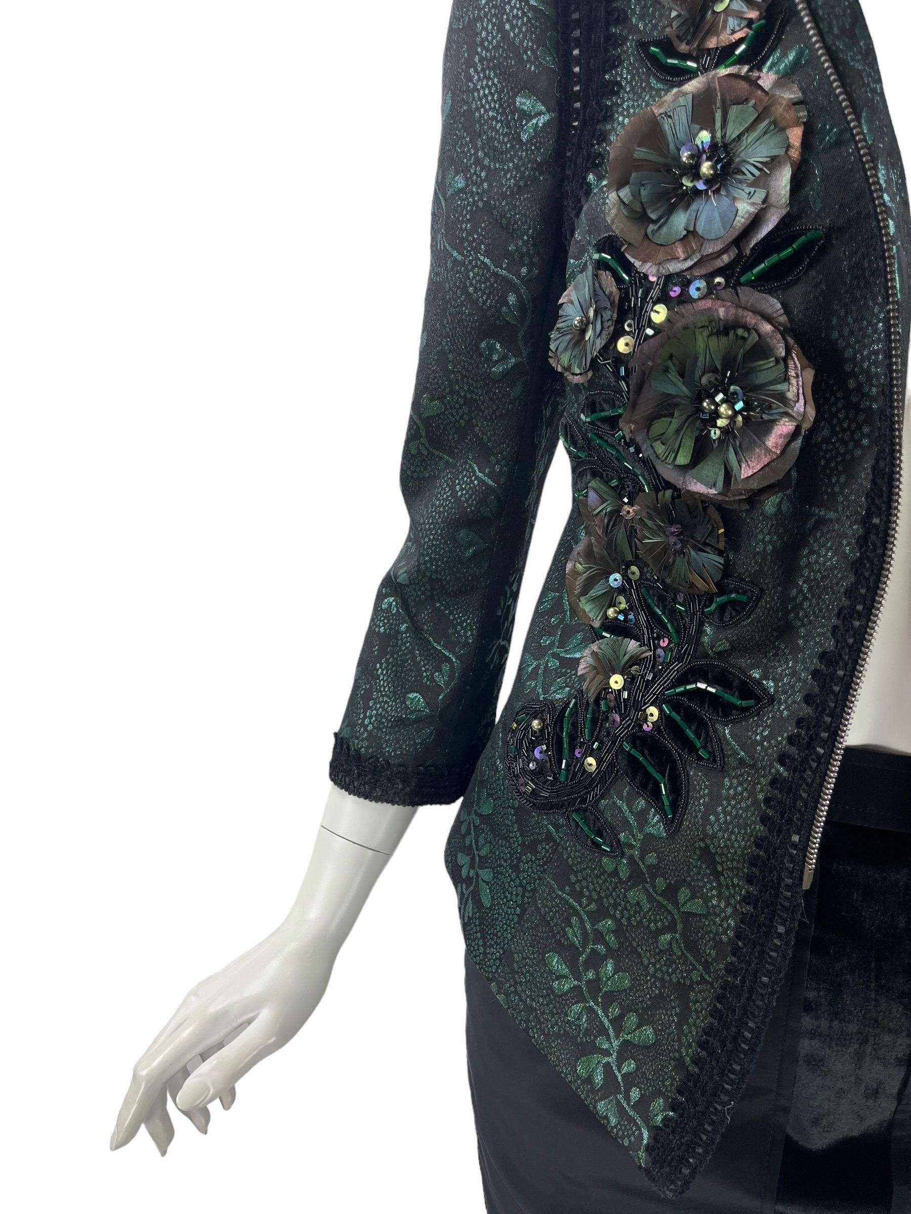 Andrew Gn Beaded and Feather Embellished Emerald Green Evening Blazer
French size 44 -  US 10/12
Velvet and Leather trim, Iridescent finish.
49% PL, 15% AC, 17% WO
17% PC, 1% cock feather, 1% glass beads. Fully lined. Zipper closure. Fabric not