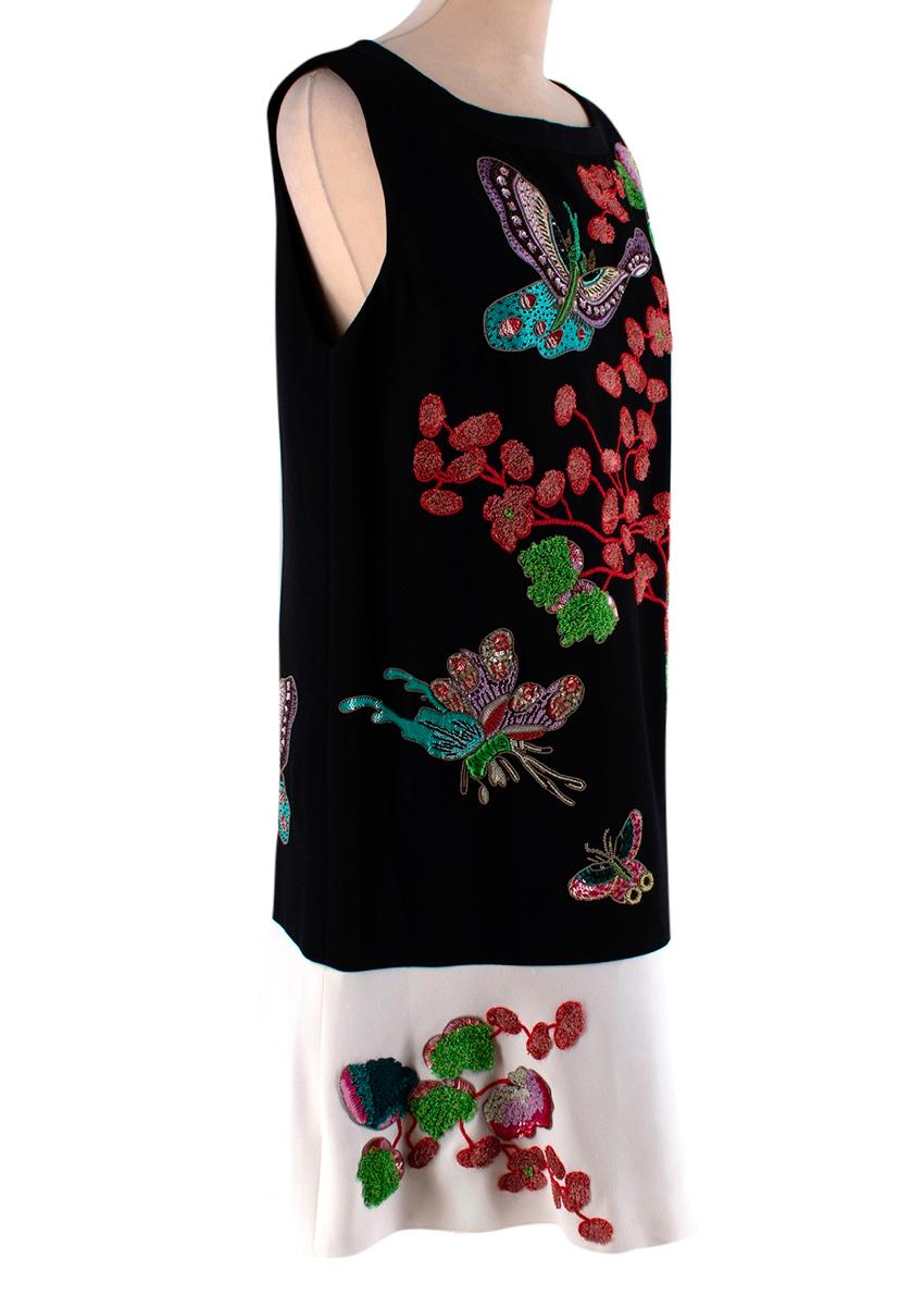 Andrew GN Black & White Embroidered Dress

- Made of a soft crepe 
- Gorgeous embroidery and beading embellishments, depicting flowers and butterflies  
- Classic cut 
- Contracting hem 
- Round neckline 
- Fully lined 
- Zip fastening to the back