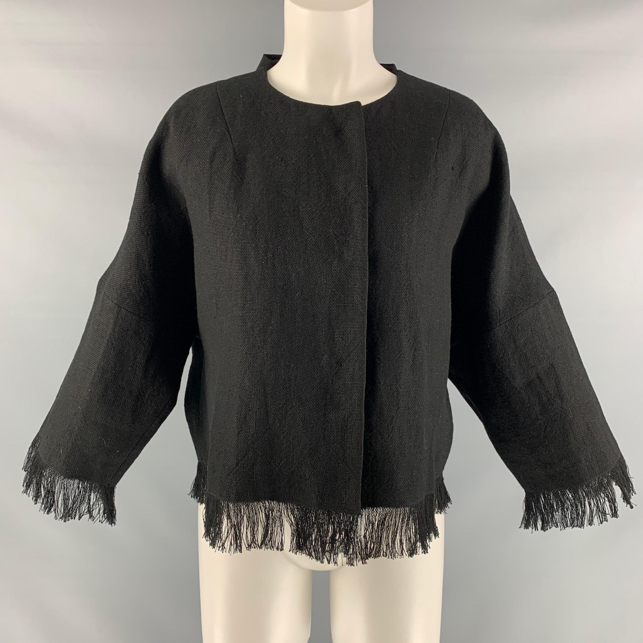 ANDREW GN oversized 3/4 sleeve jacket comes in black linen fabric featuring fringe hem detail, snap button closure and bow detail at center back. Made in France.

Excellent Pre-Owned Condition.
Marked: 36

Measurements:

Shoulder: 17 in.
Bust: 44
