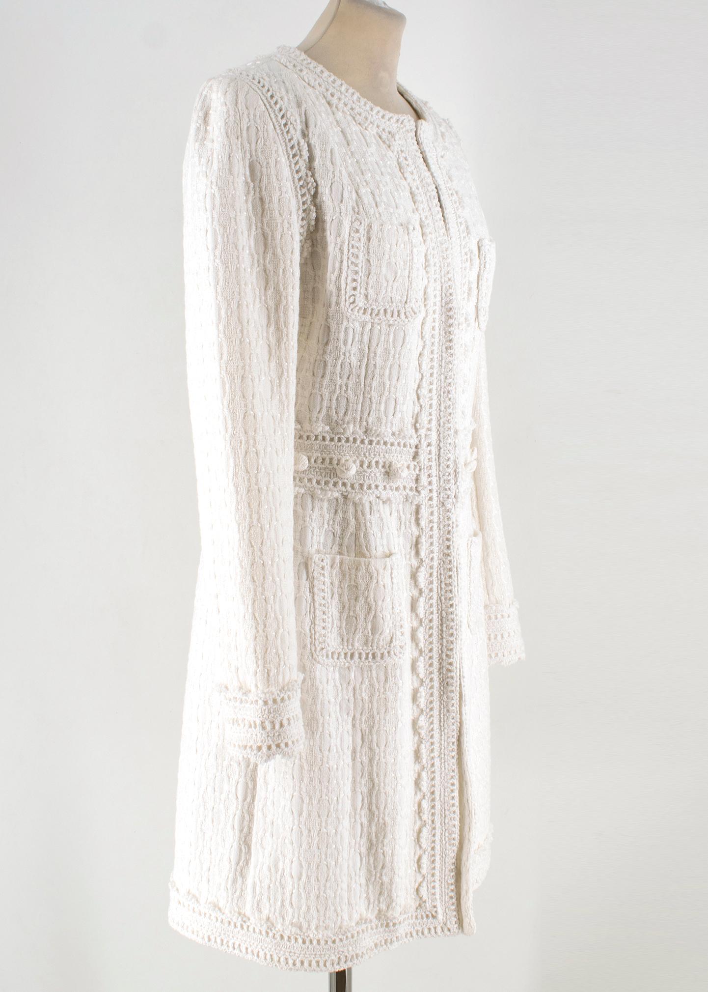 Andrew GN white collarless tweed coat

- White, heavyweight cotton-blend tweed 
- Collarless, round neck, long sleeves 
- White crochet-trimmed neckline, waistband, placket and hemline 
- Front patch pockets 
- White crochet-covered decorative waist