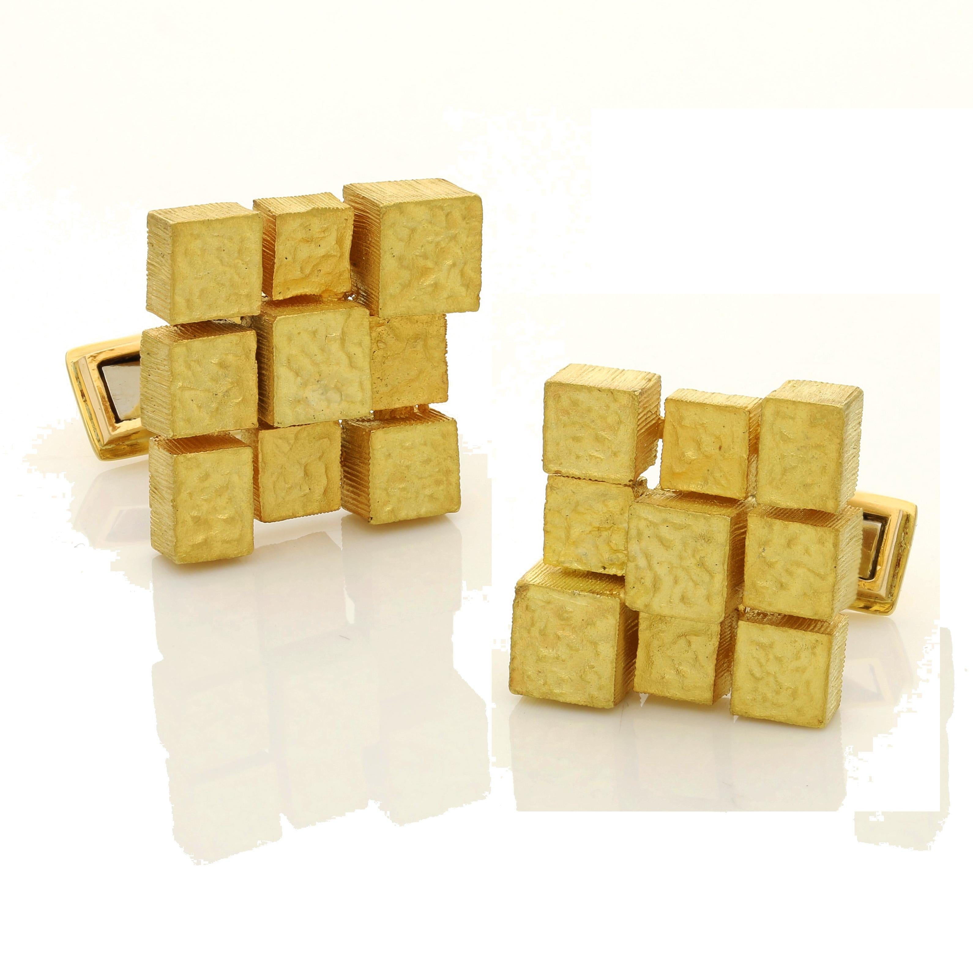 18 Carat yellow gold signed Grima and with maker's marks and London assay marks for 1970
Cufflinks heads 2cm x 2cm
25 grams

A pair of 18 Carat yellow gold cufflinks by Andrew Grima 1970, each single ended cufflink designed as a square composed of