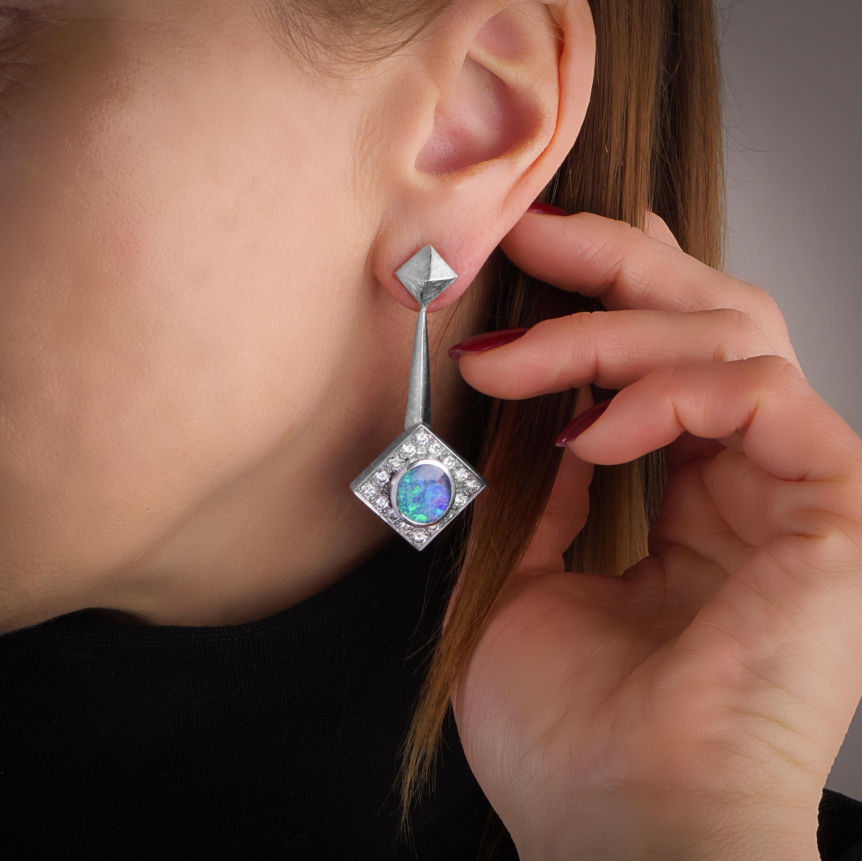 Andrew Grima 18KT Gold Opal Earrings
Made in 1990's, London.

Design Overview: These earrings, crafted by Andrew Grima, are a sophisticated example of mid-20th-century modernist jewelry design, showcasing a unique blend of geometric shapes and