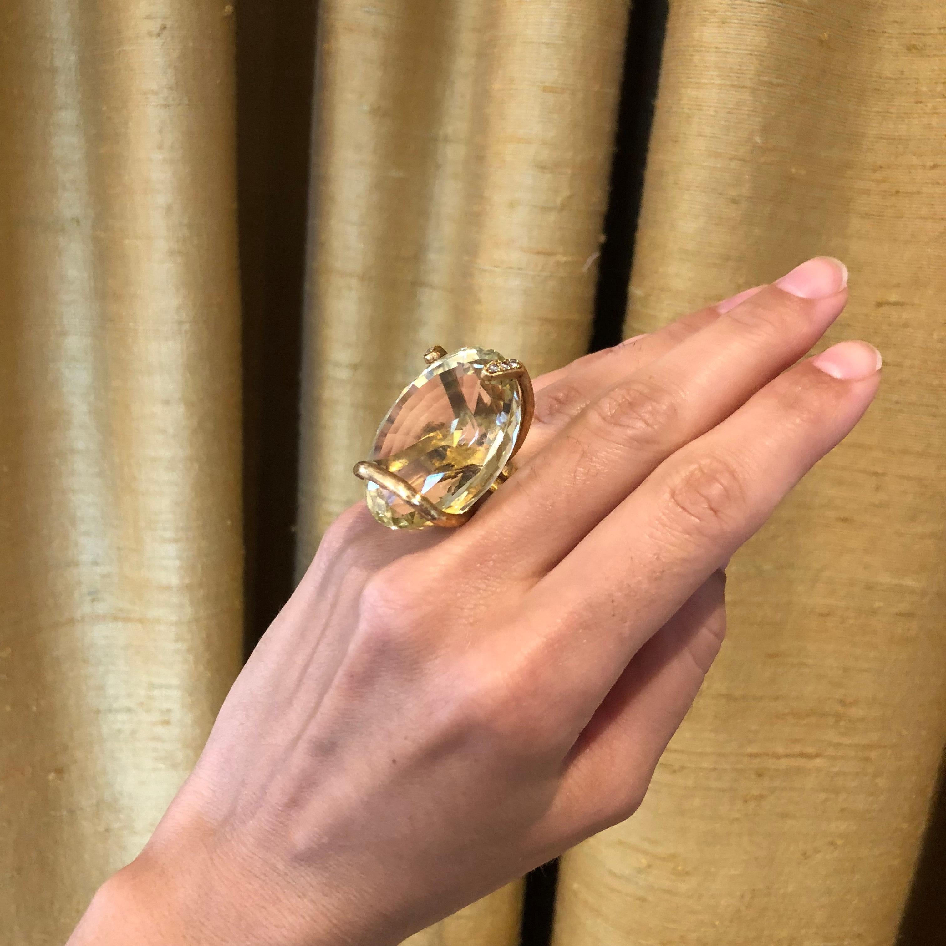 A faceted oval citrine, diamond and engraved 18 karat gold cocktail ring, by Andrew Grima, 1973. Signed Grima. Stamped with maker's mark AGLtd. London hallmark date letter 