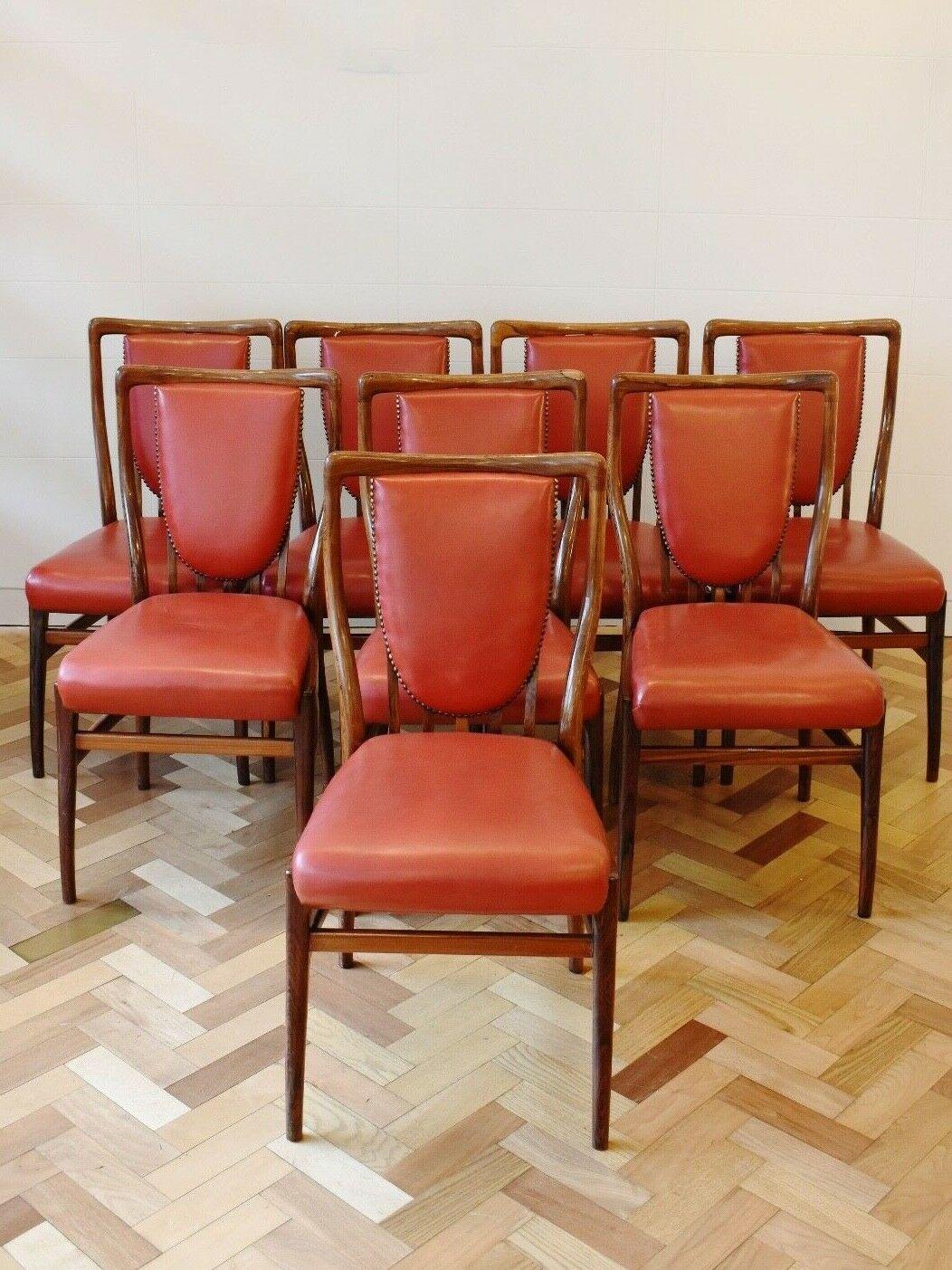 A superb set of 8 1950's Rosewood dining chairs by British designer, Andrew J. Milne - Originally sold in Heal's.

Exceptional quality this set is made from solid rosewood frames with beautiful colour and rosewood grain pattern throughout, the red