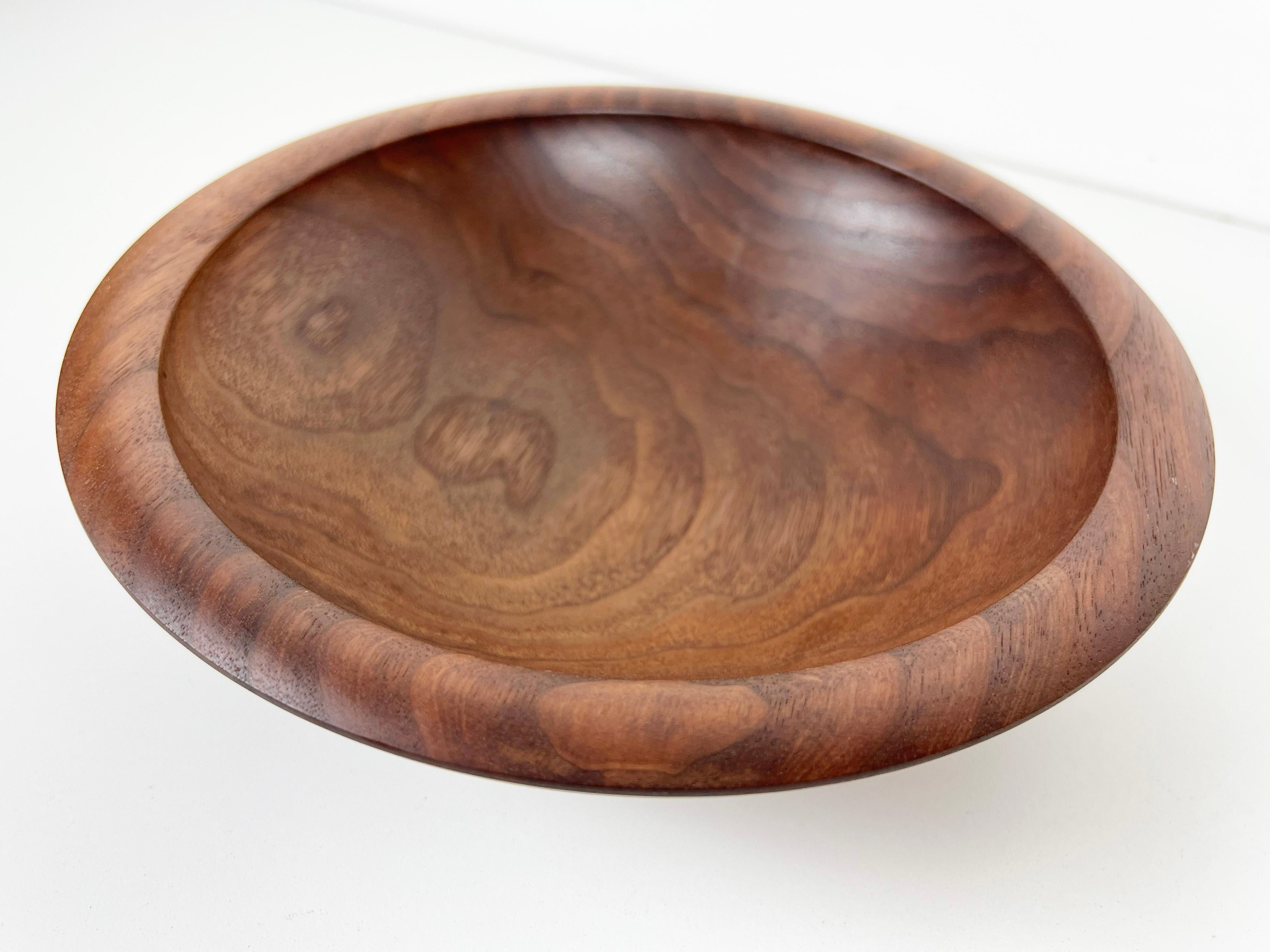 Hand-turned solid wood Champlain serving bowl crafted from beautiful walnut by Andrew Pearce. Finished with food safe allergen-free wood oil.

Artist: Andrew Pearce

Year: 2000s

Origin: Vermont, USA

Dimensions: 2.75