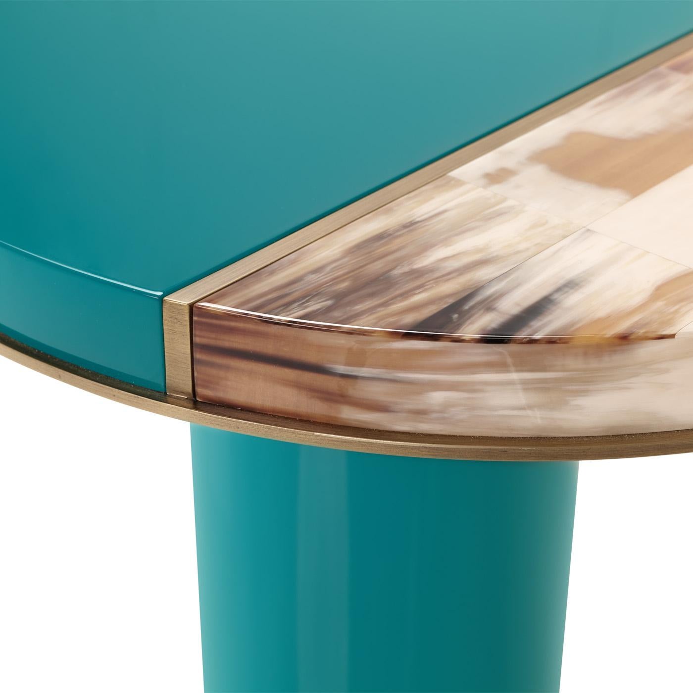 Andria is a refined side table that finds its expressive power in the masterful blend of materials. The top is handcrafted from wood with lacquered water blue finish and adds a captivating appeal to the design. It is elevated by an elegant insert in