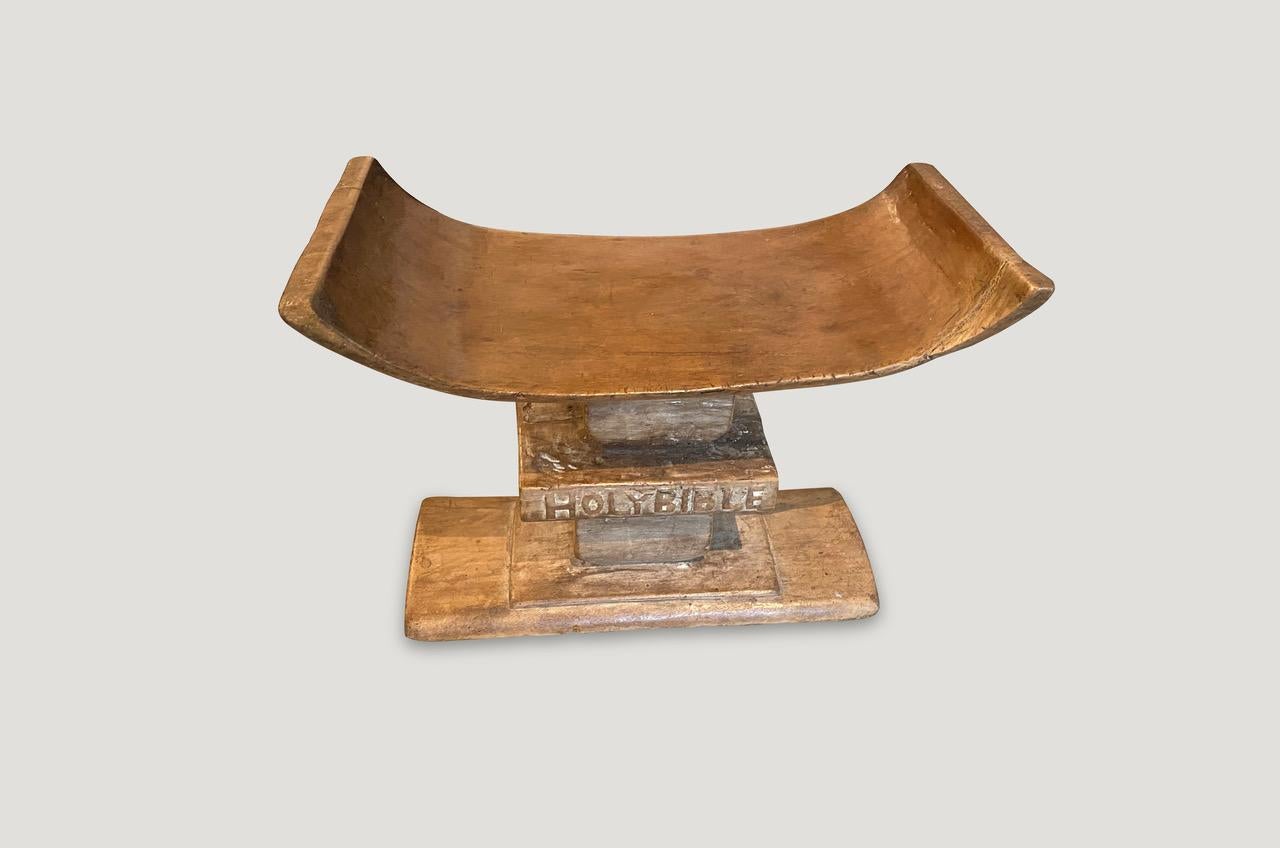 Lovely patina on this antique bench or stool hand carved from a single piece of wood from West Africa, early 20th century. Incorporated in the base is a hand carved bible.

This bench was sourced in the spirit of wabi-sabi, a Japanese philosophy