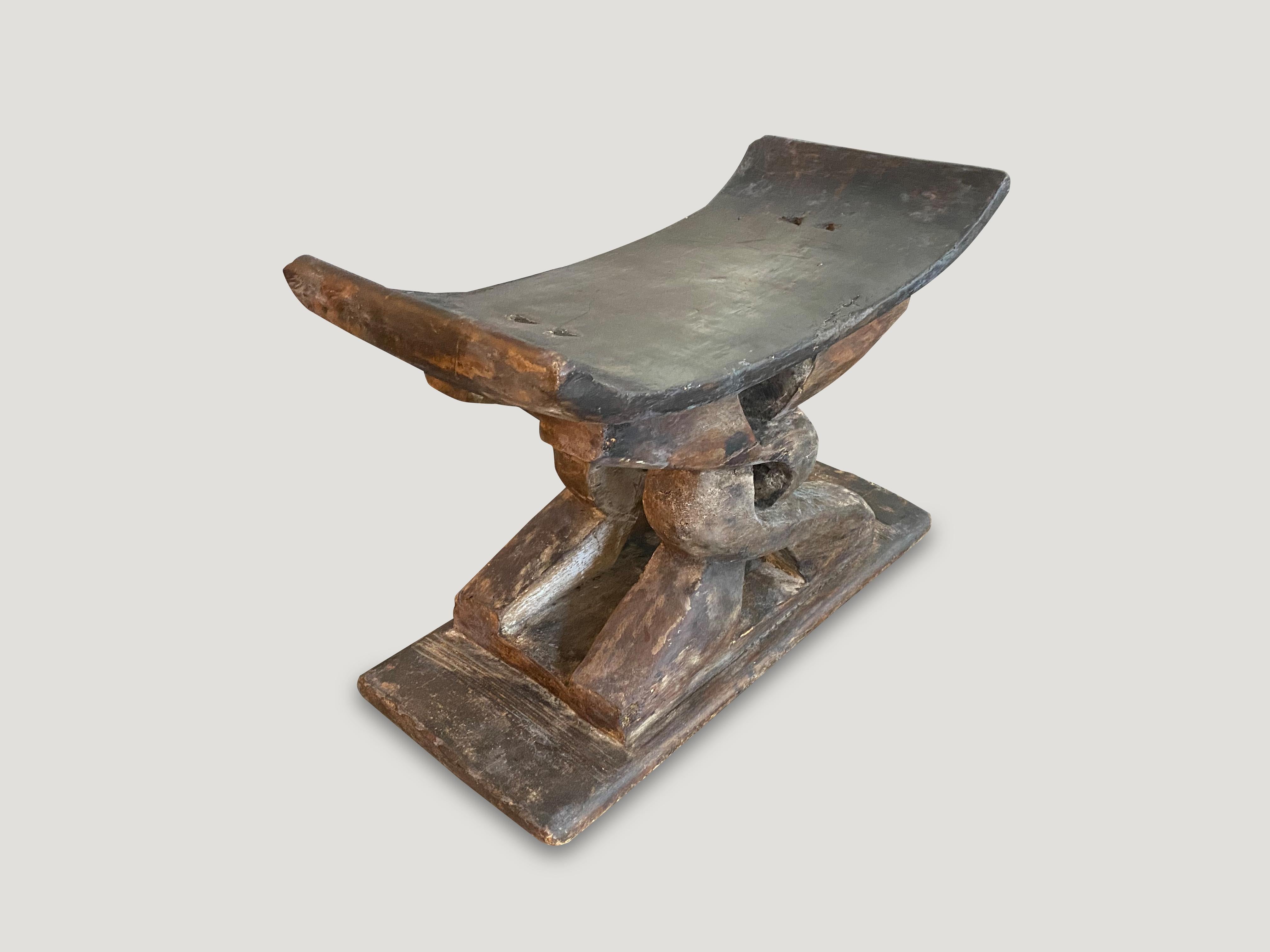 Lovely patina on this antique bench or stool hand carved from a single piece of wood from West Africa, early 20th century.

This bench was sourced in the spirit of wabi-sabi, a Japanese philosophy that beauty can be found in imperfection and