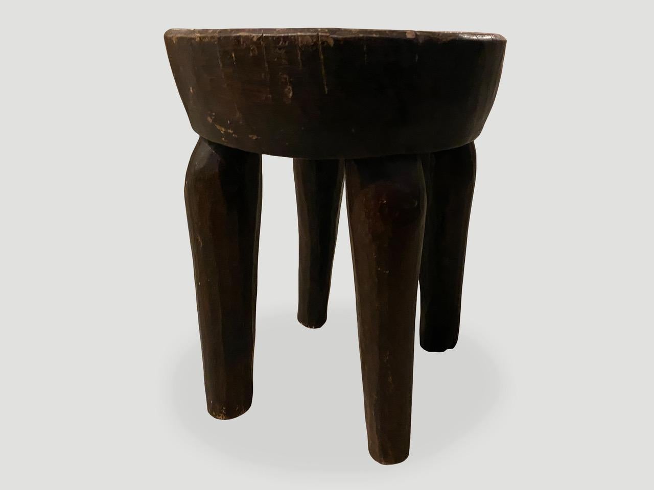 Antique African side table or stool hand carved from a single block of mahogany wood. The top is a thick bevel with beautiful hand carved legs and lovely patina. We only source the best.

This side table or stool was sourced in the spirit of
