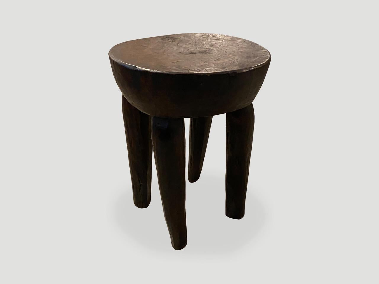 Antique African side table or stool hand carved from a single block of mahogany wood. The top is a thick bevel with beautiful hand carved legs. We only source the best.

This side table or stool was sourced in the spirit of wabi-sabi, a Japanese