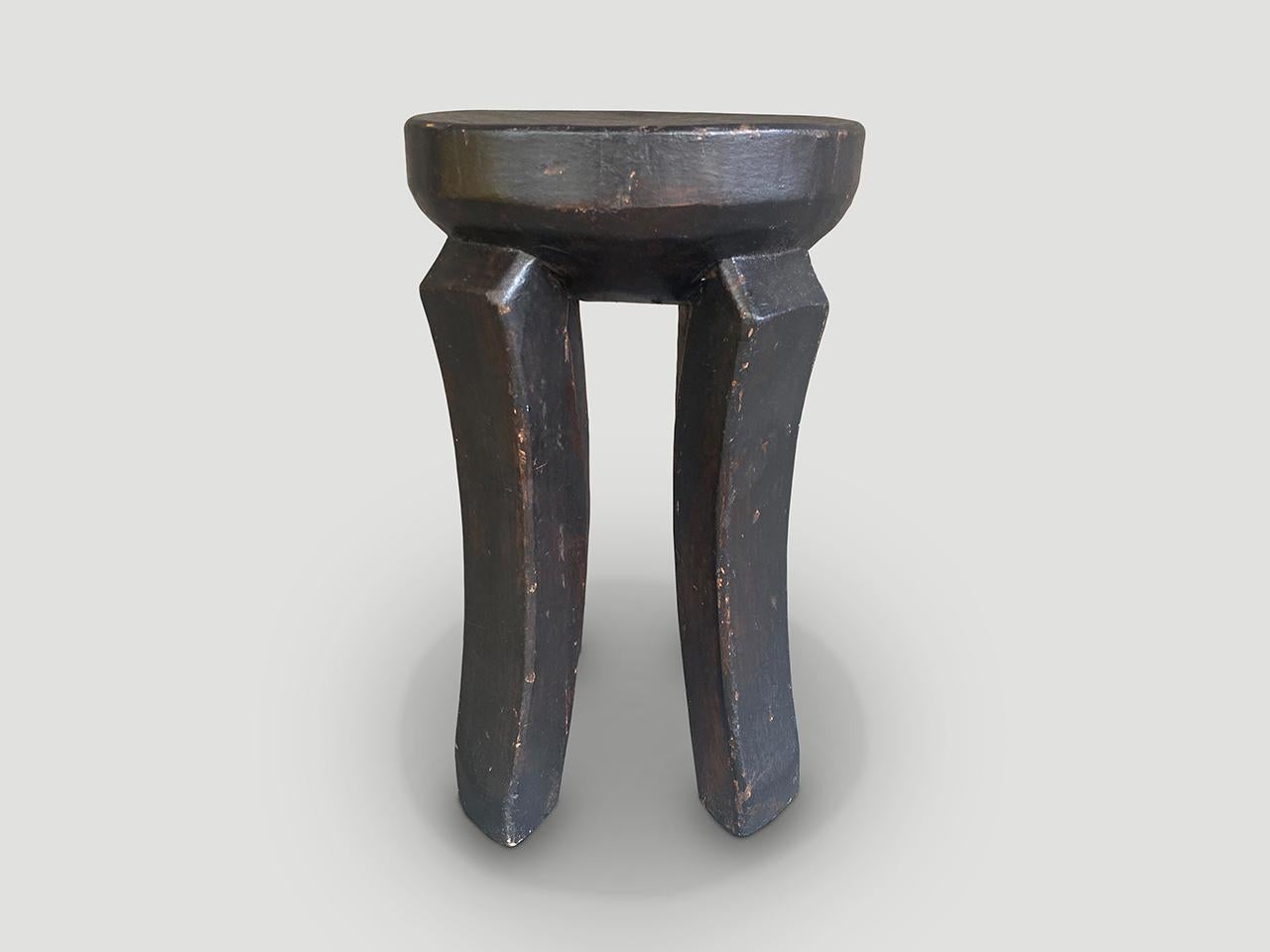 Antique African side table or stool hand carved from a single block of mahogany wood. The top is a thick bevel with beautiful hand carved legs. We only source the best. We have a pair. The price and images reflect the one shown.

This side table