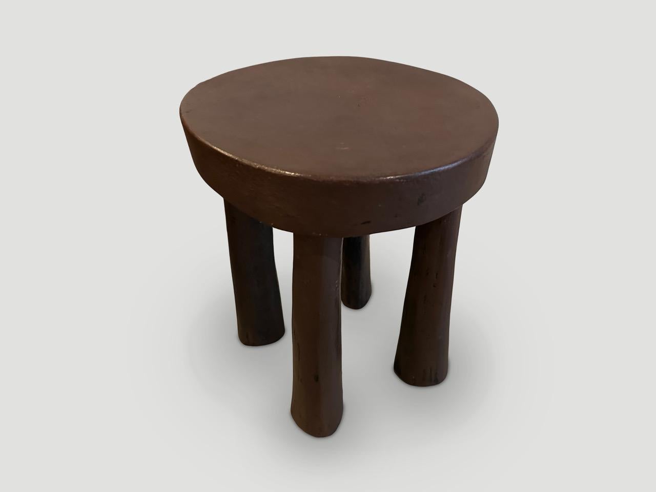 Antique African side table or stool hand carved from a single block of wood. 

This side table or stool was sourced in the spirit of Wabi-Sabi, a Japanese philosophy that beauty can be found in imperfection and impermanence. It is a beauty of