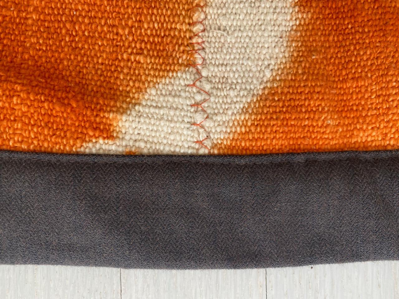 Vibrant burnt orange and ivory vegetable dyed African textile. We added a chocolate brown linen border. Great on a sofa, bed or a wall hanging. This textile can also be used as a rug with a rug pad.

Andrianna Shamaris. The Leader in Modern