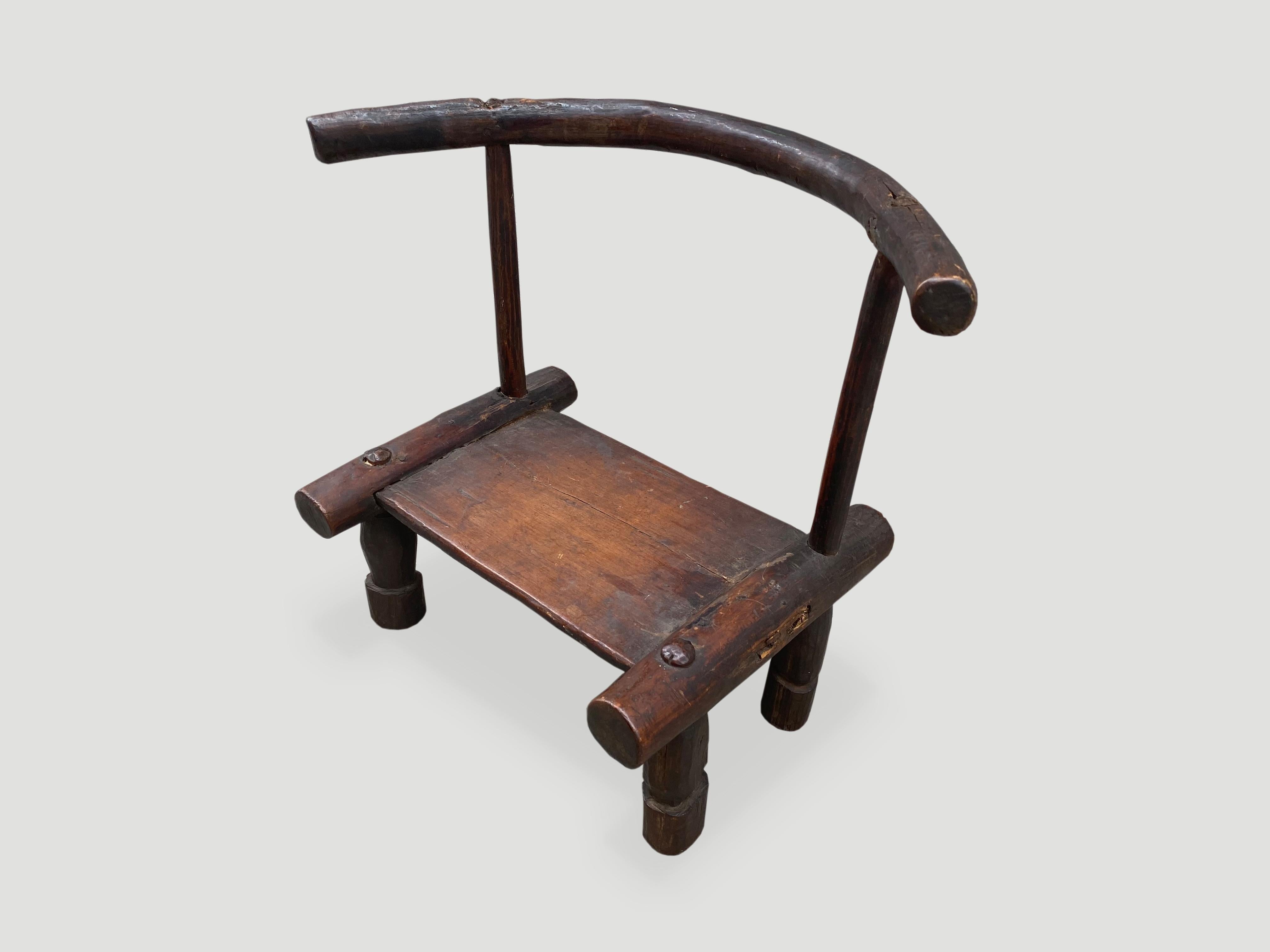 Beautiful patina on this 19th century hand carved wooden chair from the Ivory Coast of Africa. This can also be used as a low side table. A piece of art. We only source the best.

This chair was sourced in the spirit of wabi-sabi, a Japanese