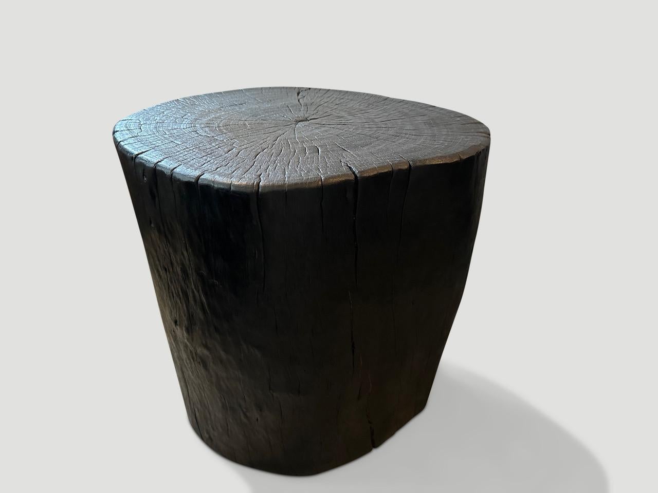 Reclaimed lychee wood side table. Charred, sanded and sealed whilst respecting the natural organic shape and revealing the beautiful wood grain. 

The Triple Burnt Collection represents a unique line of modern furniture made from solid reclaimed