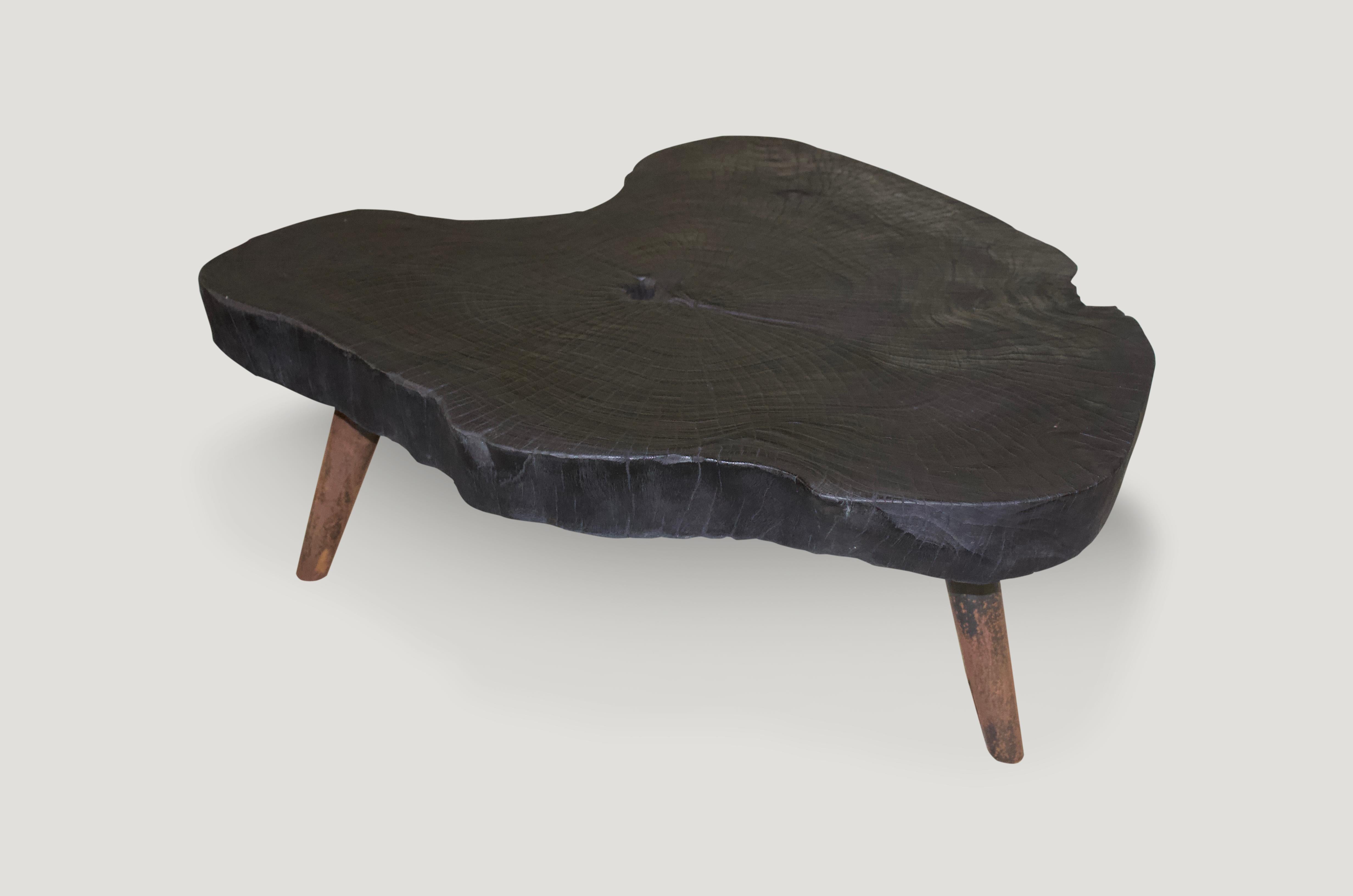 Single four inch slab teak wood coffee table. Charred and set on a mid century style burnt metal base, which we can also finish in pure black if preferred. We have a collection available, all sliced from the same log. The price represents