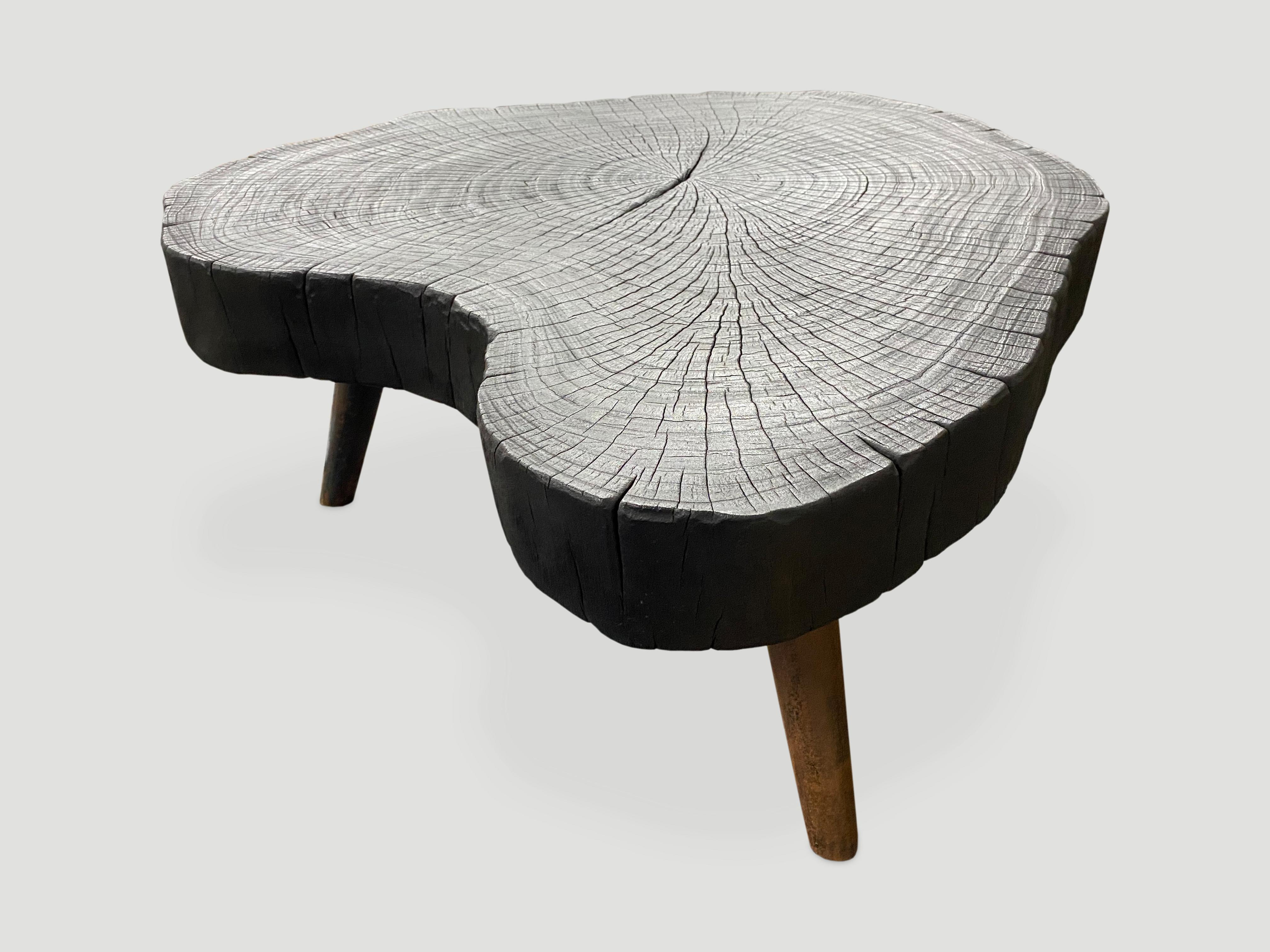 Single four inch slab coffee table. Charred and set on a midcentury style burnt metal base, which we can also finish in pure black if preferred. We have a pair available, sliced from the same log. The price and size reflect the one shown.

The