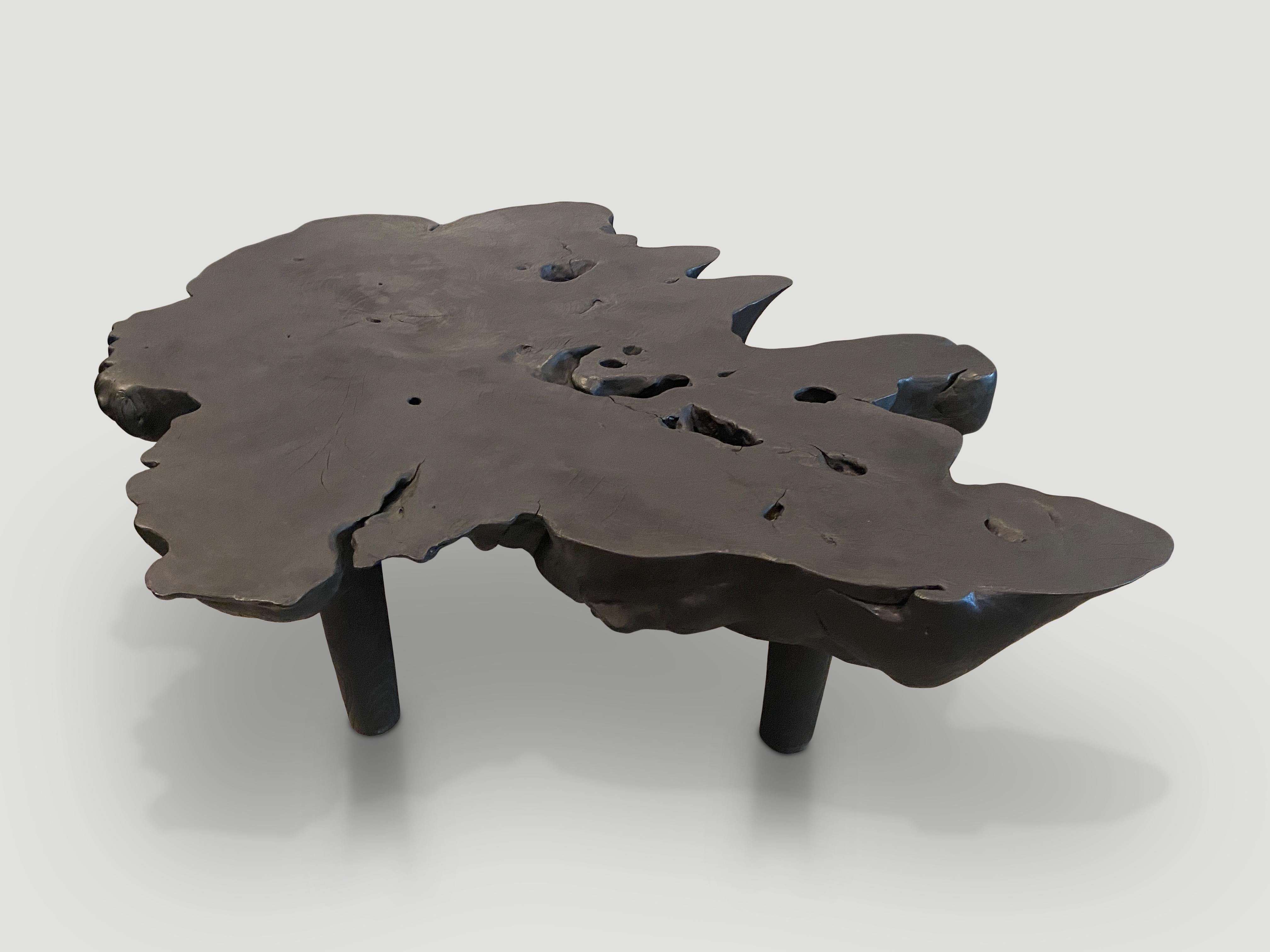Impressive five inch single slab reclaimed teak wood coffee table. Charred, sanded and sealed exposing the beautiful grain of the wood. Floating on minimalist cylinder legs. Organic with a twist. 

The Triple Burnt Collection represents a unique