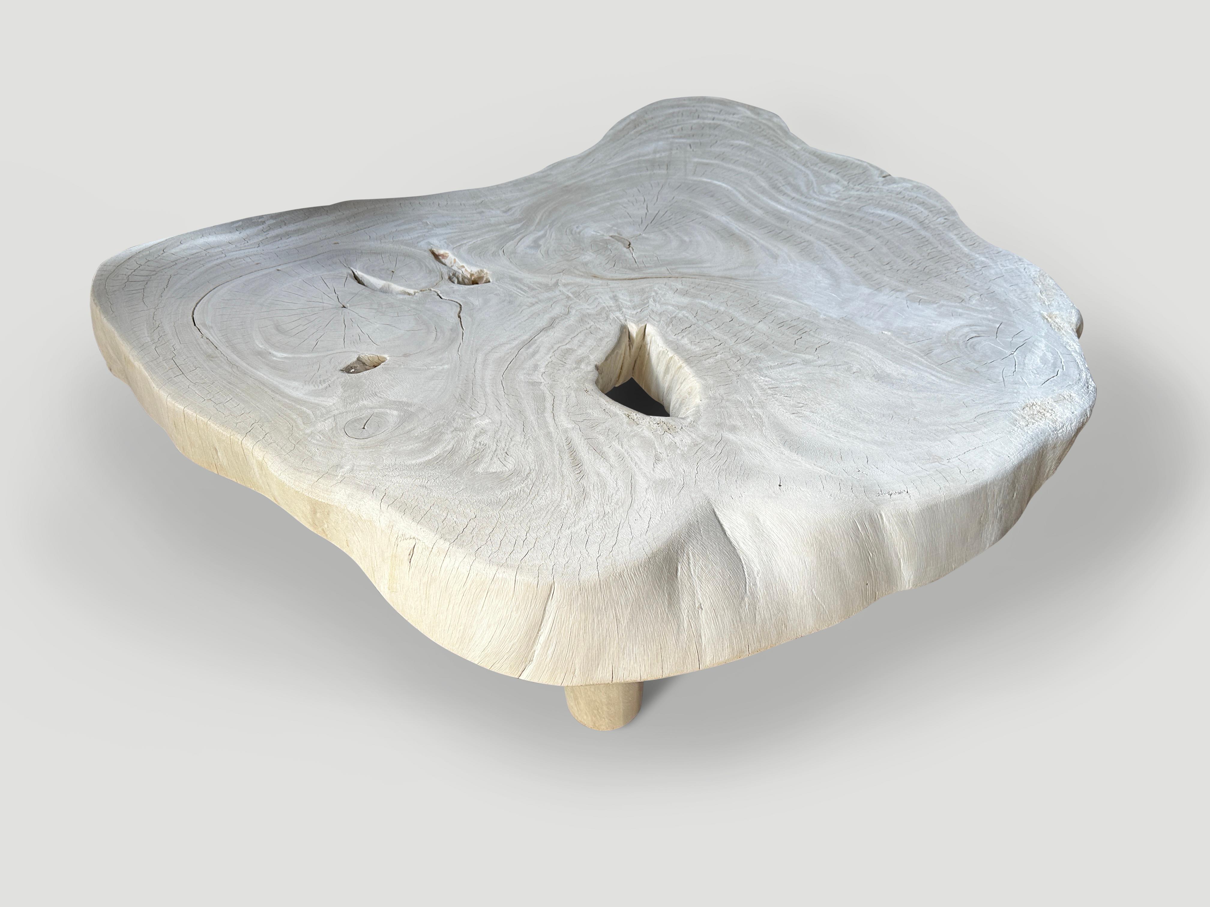 Impressive four inch single slab reclaimed suar wood coffee table. Fully bleached revealing the beautiful wood grain. Floating on mid century style cone legs. It’s all in the details. Full dimensions; 65 x 53 x 16