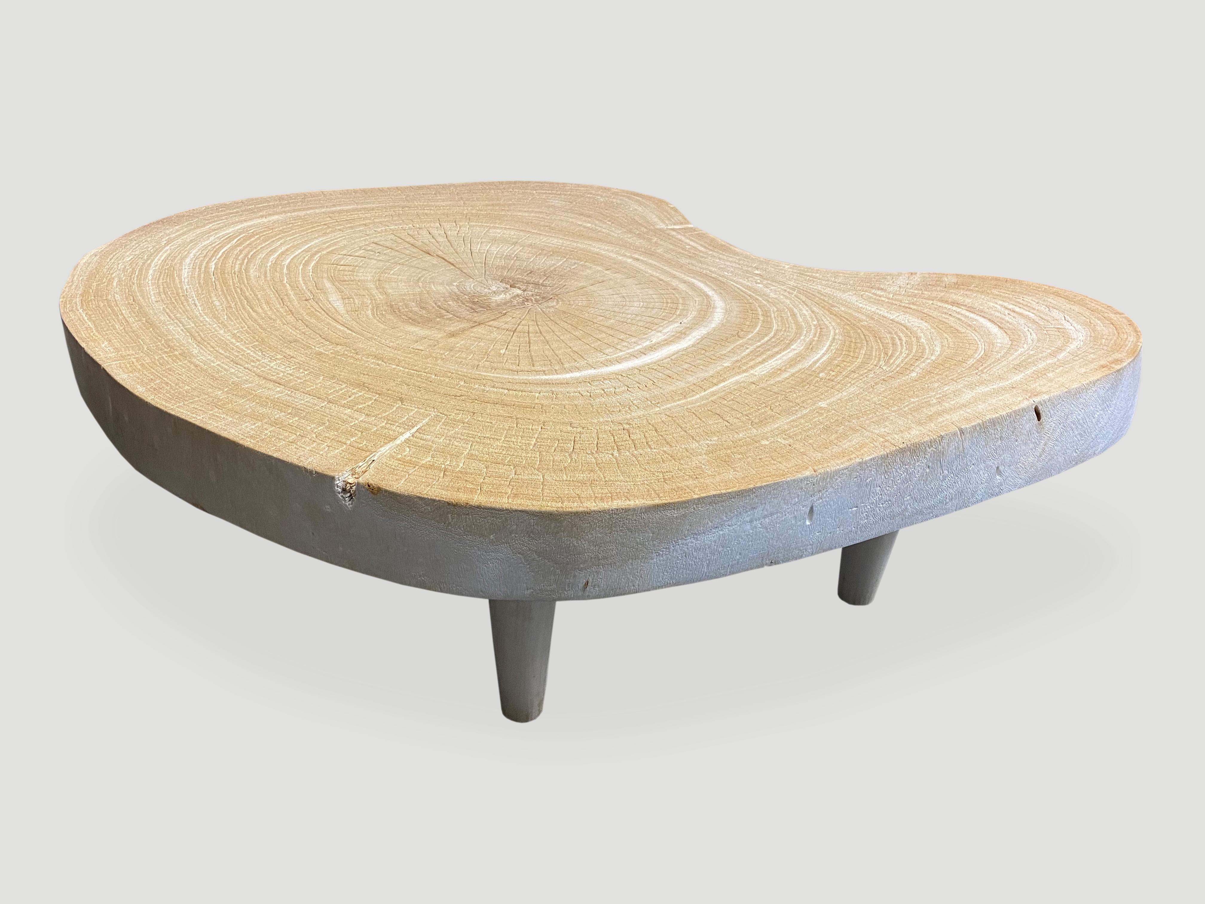 Impressive four inch slab coffee table, set on cone shaped mid century style legs. The wood is unknown though indigenous to Indonesia. We love the natural way it ‘crackled’ after we applied the bleach to the wood and left in the sun to turn this