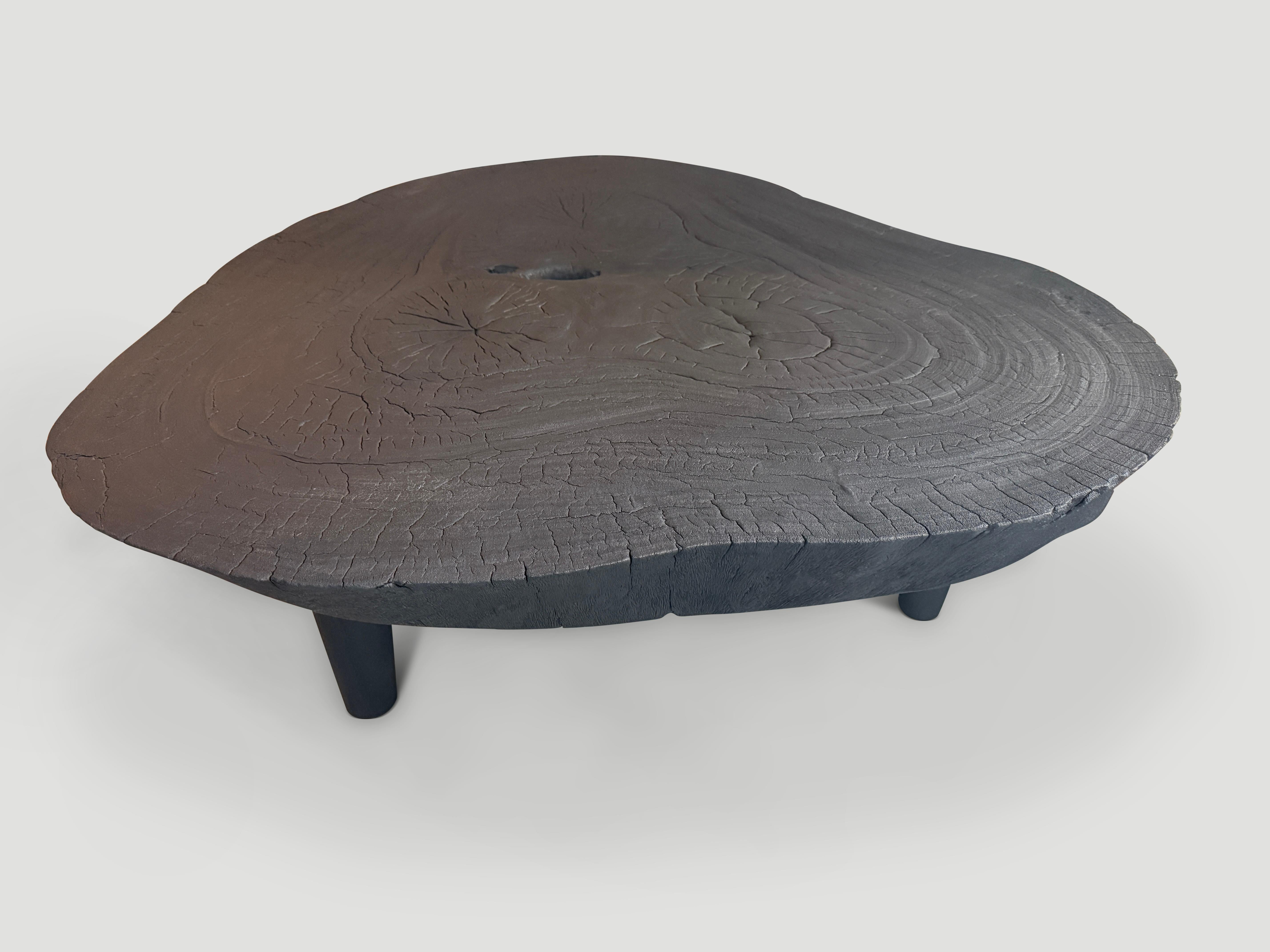 Impressionnante table basse en dalles de 5 pouces, posée sur des pieds en forme de cône de style milieu de siècle. Le bois est inconnu mais indigène en Indonésie. Ce bois réagit bien à la finition carbonisée, ce qui donne un bel effet craquelé