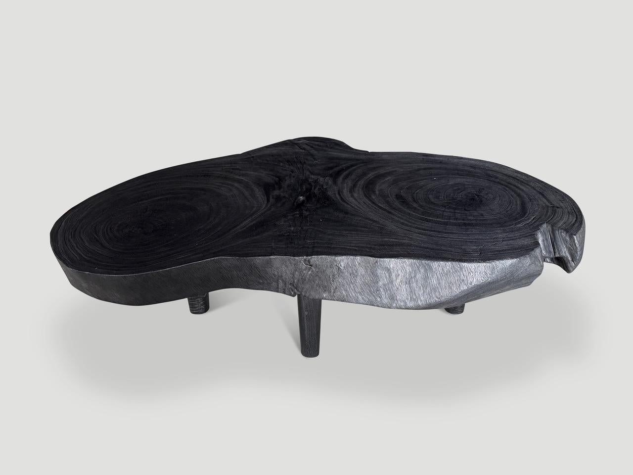 Beautiful four and a half inch slab coffee table hand made from reclaimed suar wood. This impressive top is supported by mid century style cone legs. Charred sanded and sealed revealing the unique wood grain. It’s all in the details. 

The Triple
