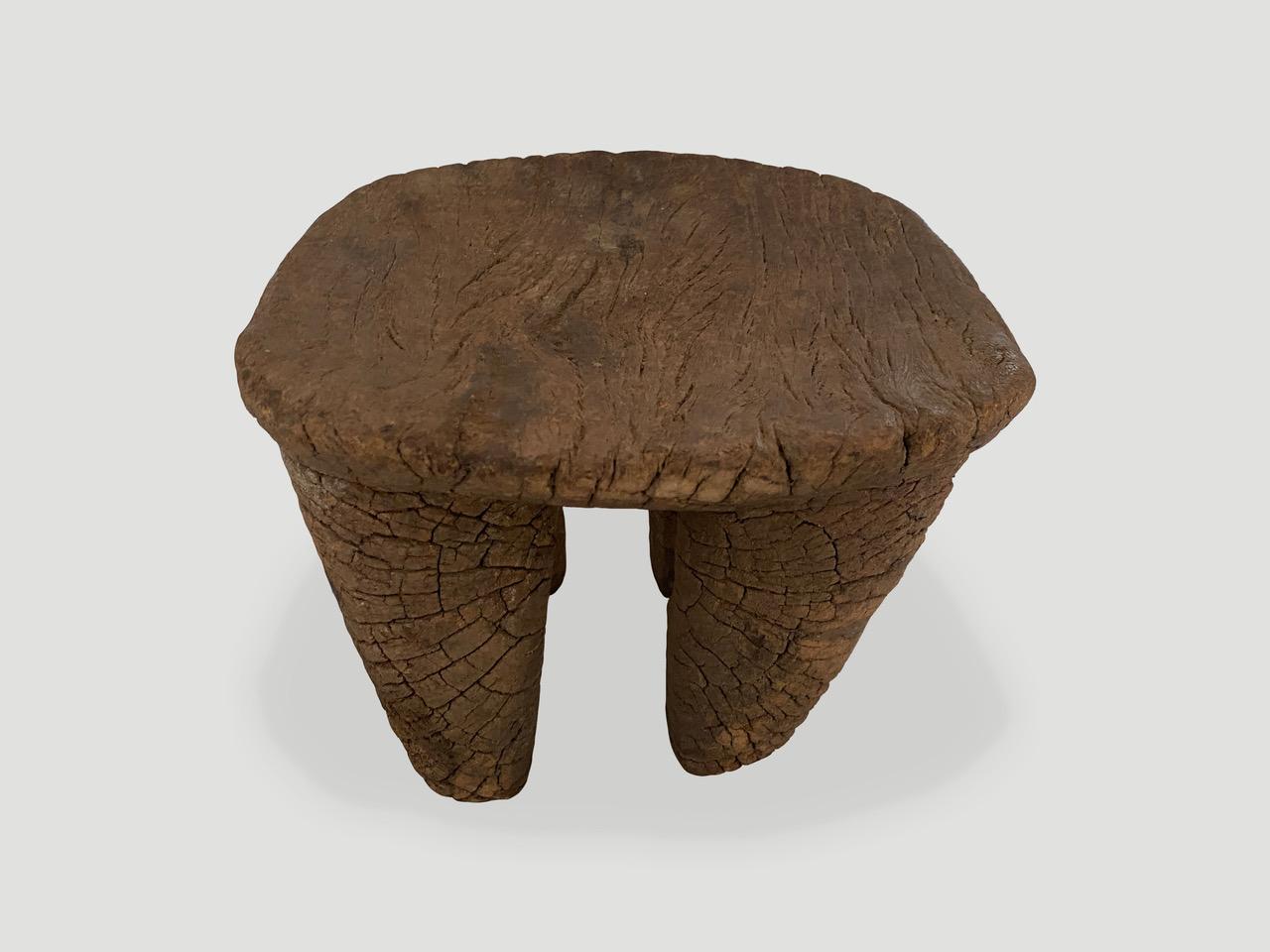 Lovely patina on this beautiful African stool or side table hand carved from a single block of wood that looks fossilized. Great for placing a book or perhaps towels in a bathroom, magazines etc. We only source the best. 

This side table or stool