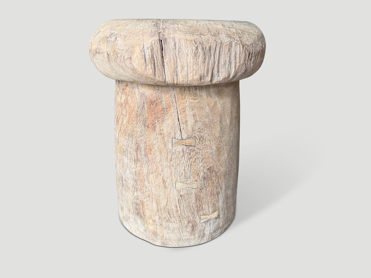 A beautiful antique rice pounder over a hundred years old has been turned upside down and repurposed as a side table. Originally the opposite hollow side was used to pound rice. We added butterfly details into the natural cracks and finished with a