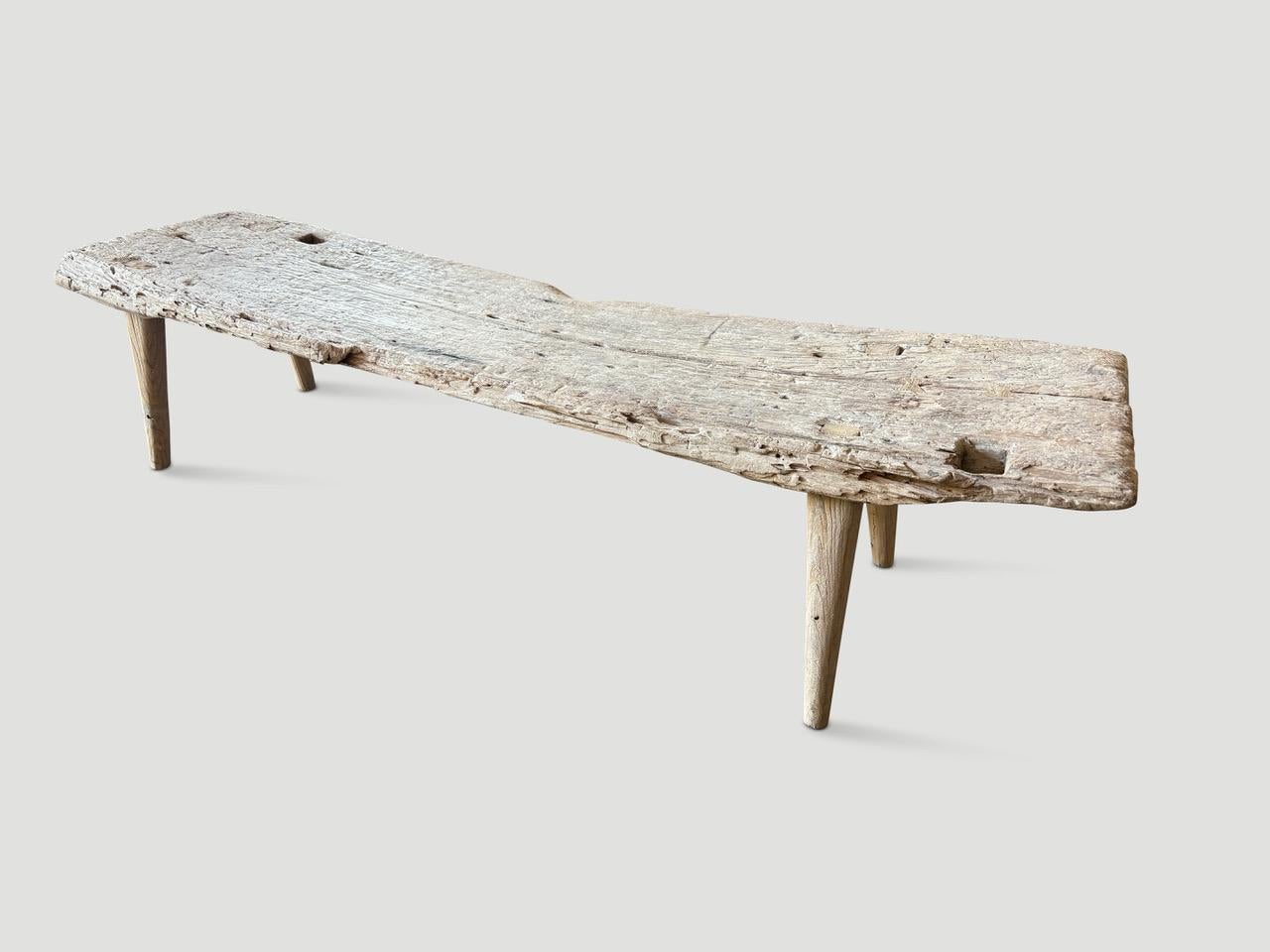 Two beautiful century old thick teak panels have been hand crafted into a one of a kind bench or chaise whilst respecting the natural organic wood. The top is supported with minimalist hand carved smooth legs. Finished with our secret ingredient
