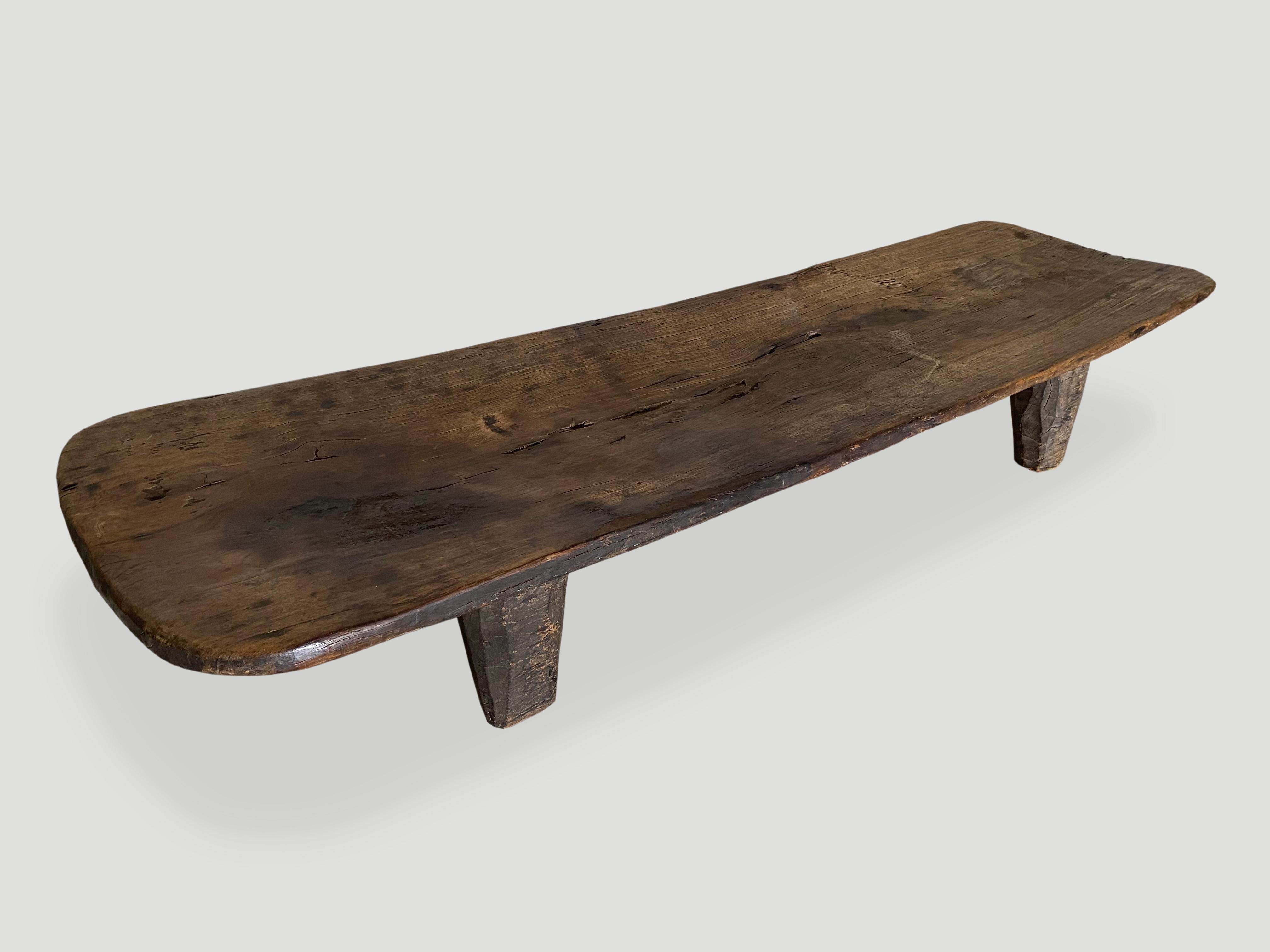 Stunning patina on this antique Senufu bed. The length and width are rare. Hand carved by the Senufo tribe from a single block of wood, native to the west coast of Africa. The wood is tough, dense and very durable. This one is unusually long and