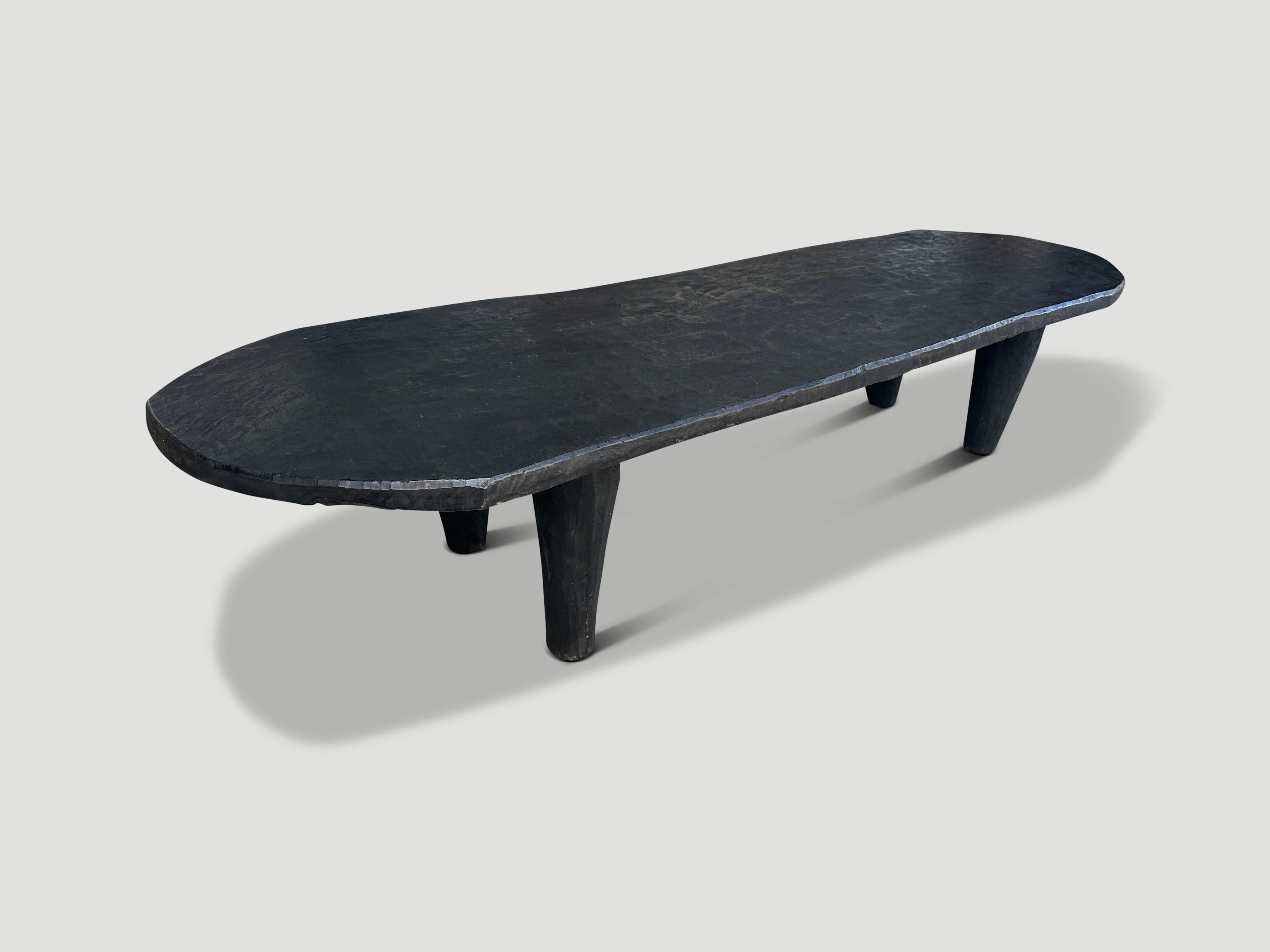 Beautiful coffee table or bench hand carved from a single block of African mahogany wood from Nigeria. Shown with carved cone style legs. The wood is tough, dense and very durable. We only source the best. Rare to find a size this long and
