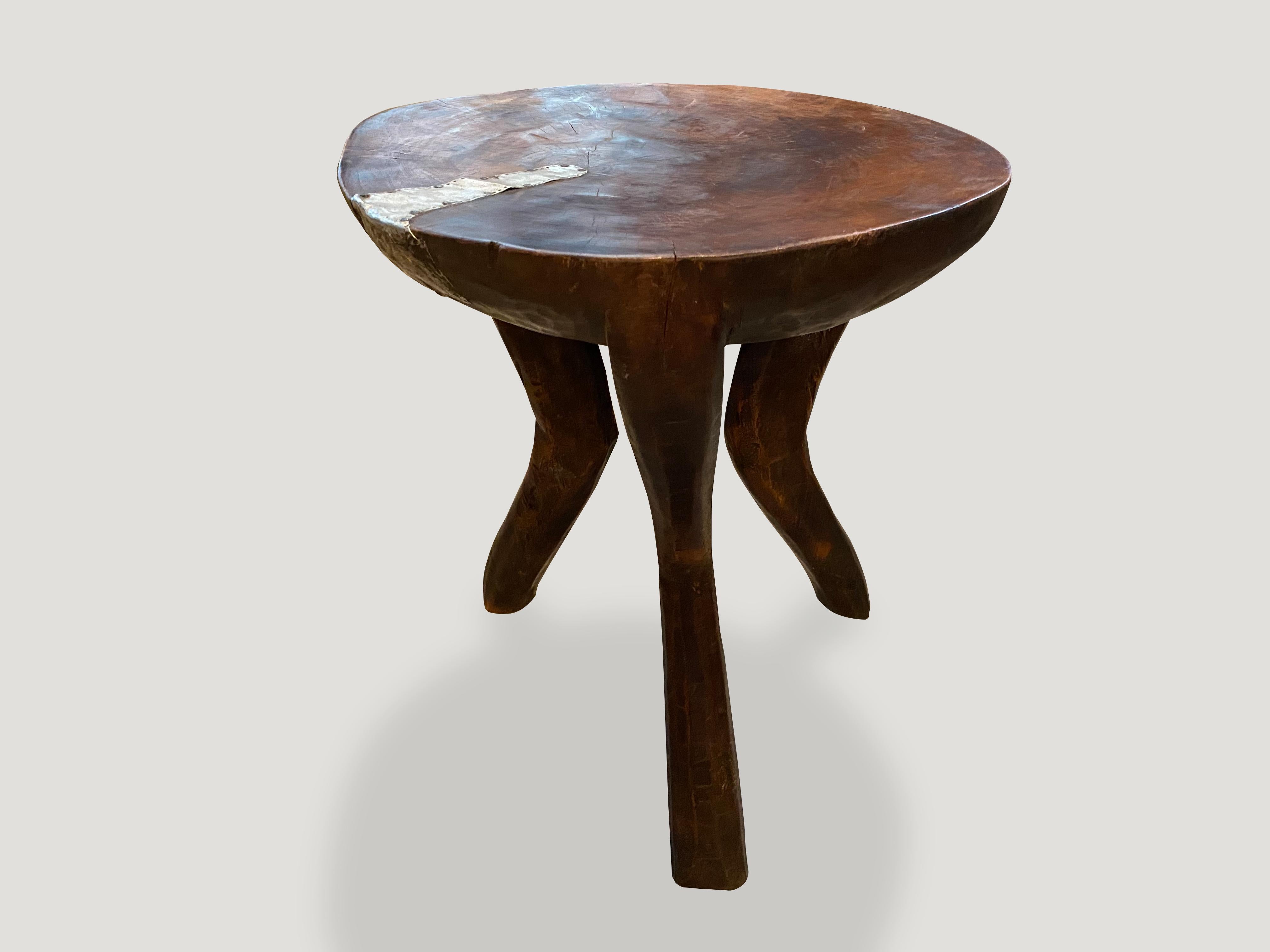 Antique African mahogany side table or stool, hand carved from a single piece of mahogany wood with lovely patina. A beautiful, versatile item that is both sculptural and usable.

This side table or stool was sourced in the spirit of wabi-sabi, a