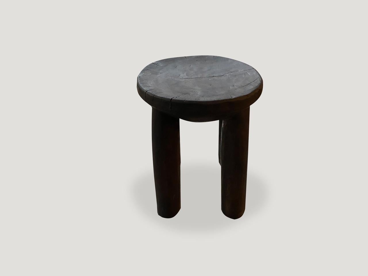 African mahogany stool or side table. Hand carved from a single piece of wood with a deep beveled top. Great for placing a book or perhaps towels in a bathroom, magazines etc. This stool or side table was sourced in the spirit of wabi-sabi, a