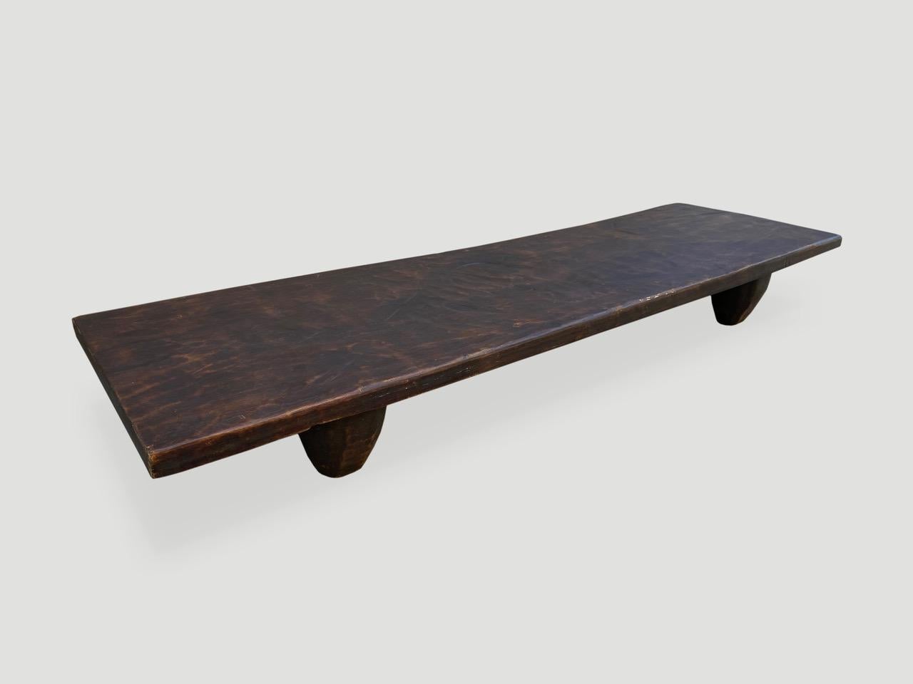 Antique coffee table or bench hand carved from a single block of wood, native to the west coast of Africa. This one is unusually long and shown with low minimalist legs. We only source the best. 

This bench or coffee table was sourced in the