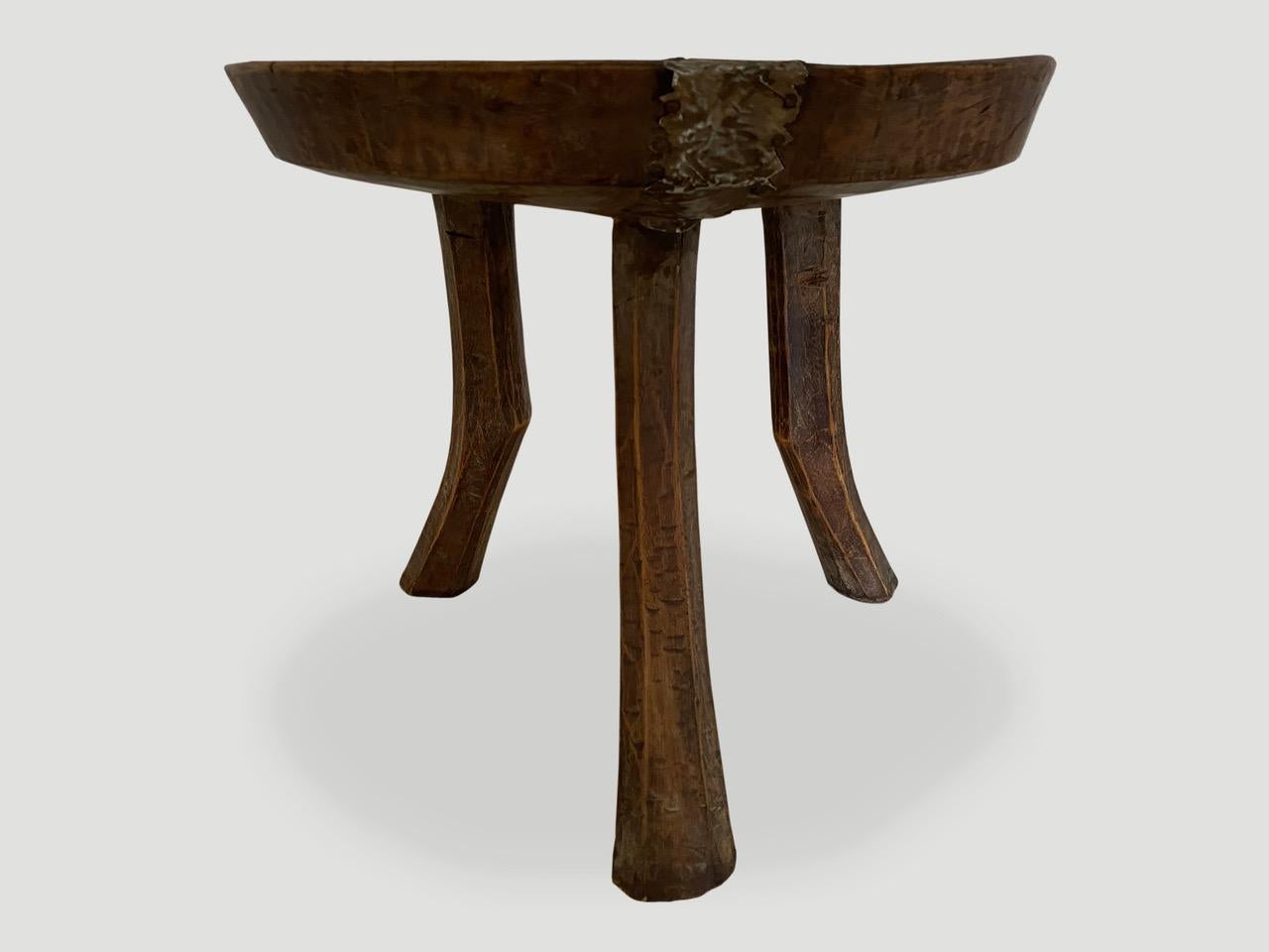 Antique African mahogany side table, hand carved from a single block of mahogany wood with lovely patina and tin overlay. A beautiful, versatile item that is both sculptural and usable.

This side table was sourced in the spirit of wabi-sabi, a
